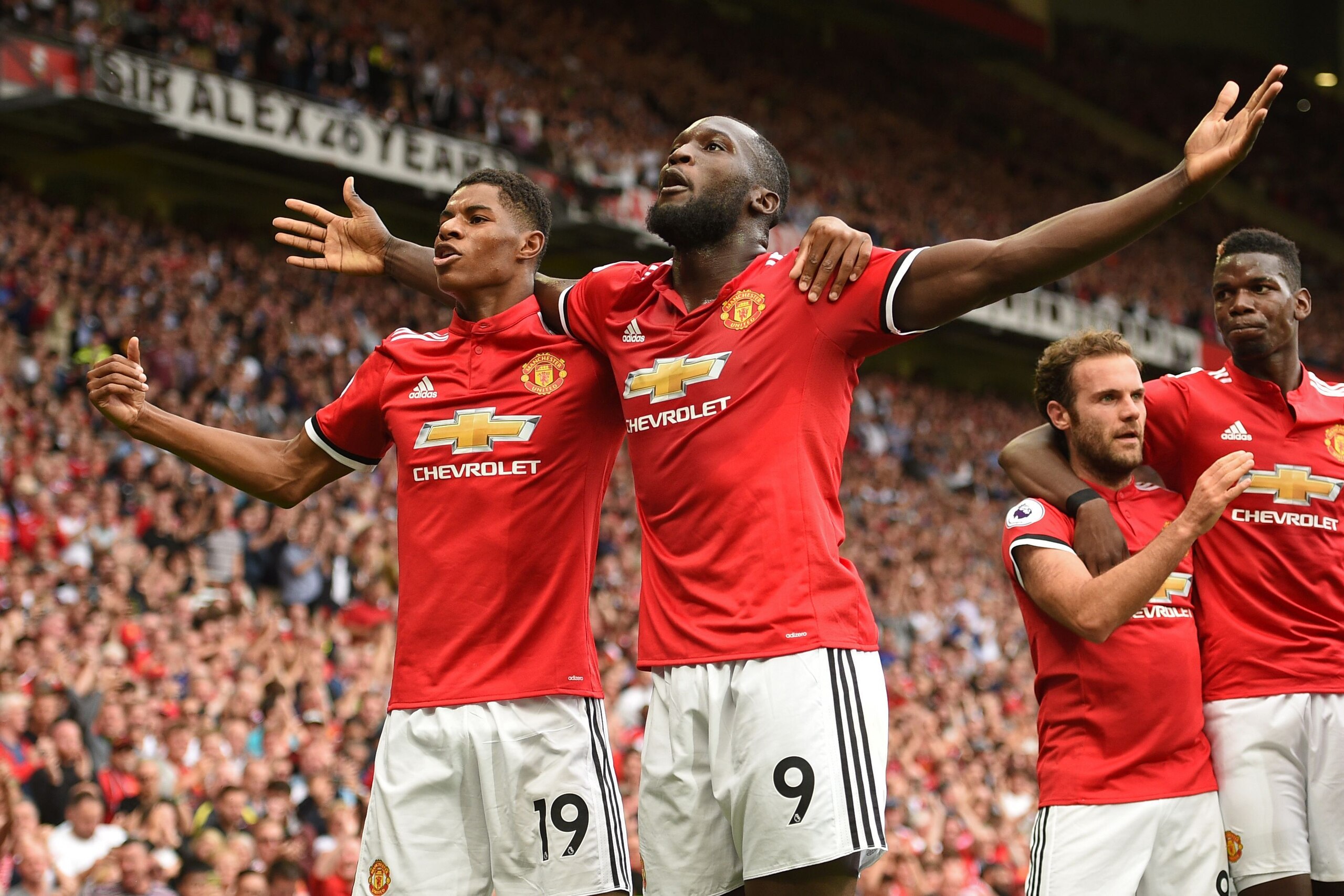 Manchester United's Belgian striker Romelu Lukaku celebrates scoring the opening goal with Manchester United's English striker Marcus Rashford during the English Premier League football match between Manchester United and West Ham United at Old Trafford i