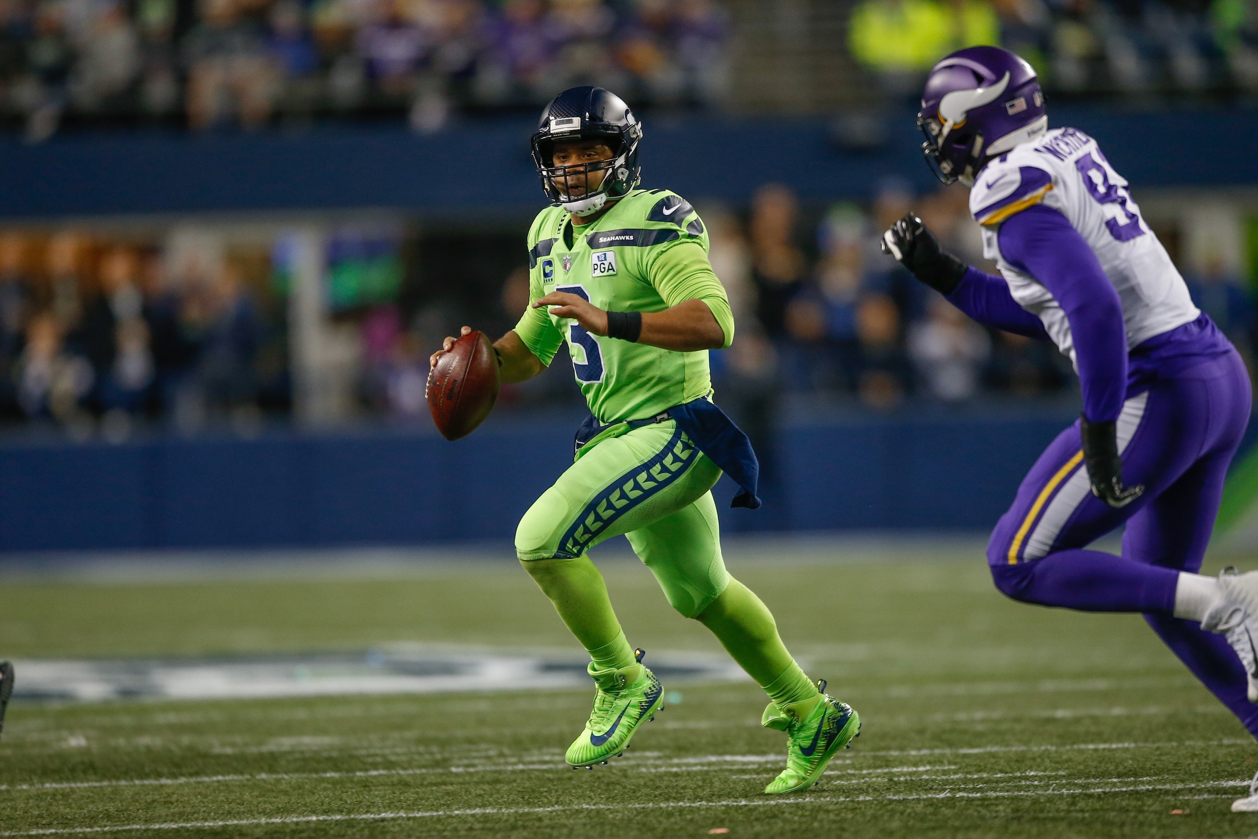 SEATTLE, WA - DECEMBER 10:  Quarterback Russell Wilson #3 of the Seattle Seahawks rushes under pressure from Stephen Weatherly #91 of the Minnesota Vikings at CenturyLink Field on December 10, 2018 in Seattle, Washington.  (Photo by Otto Greule Jr/Getty I