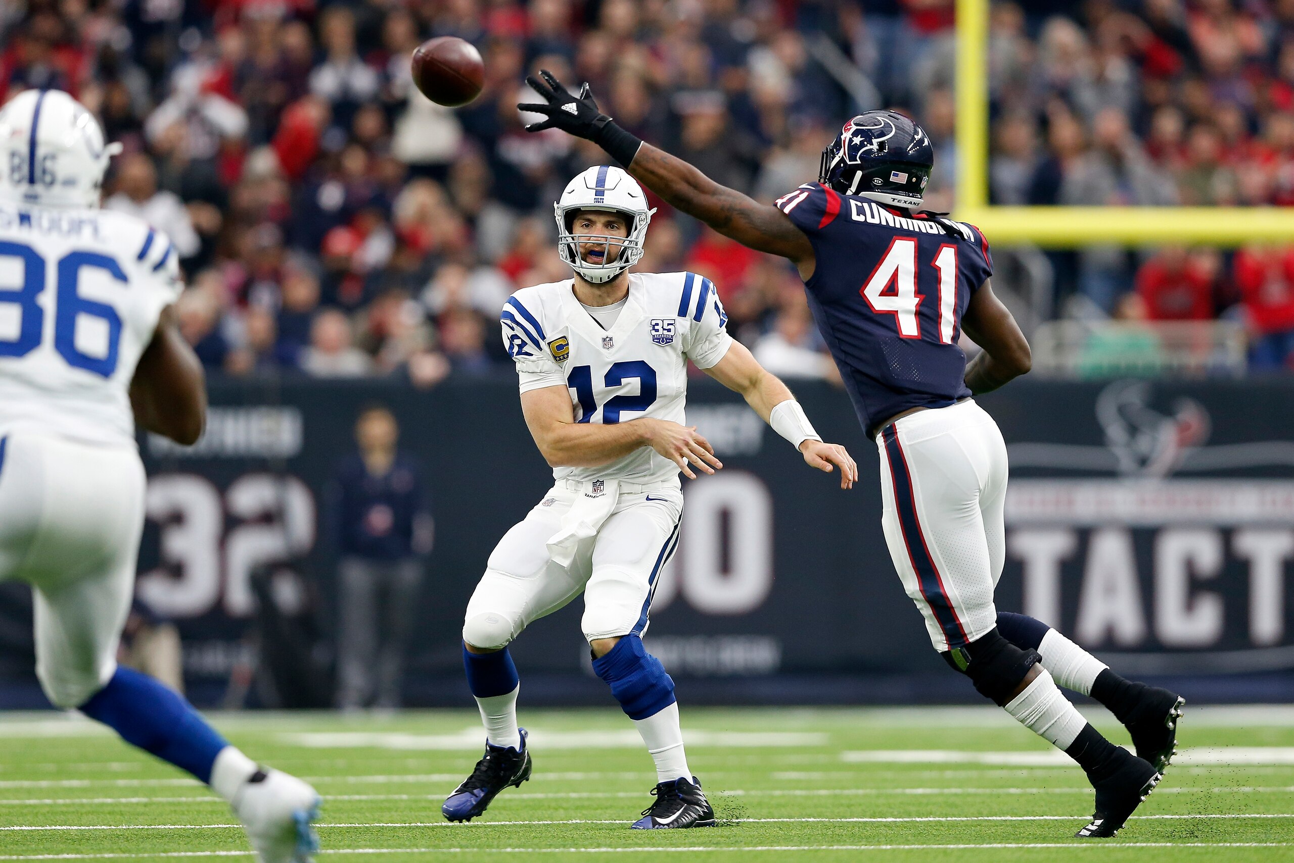 HOUSTON, TX - DECEMBER 09:  Andrew Luck #12 of the Indianapolis Colts throws a pass in the first quarter under pressure by Zach Cunningham #41 of the Houston Texans at NRG Stadium on December 9, 2018 in Houston, Texas.  (Photo by Tim Warner/Getty Images)