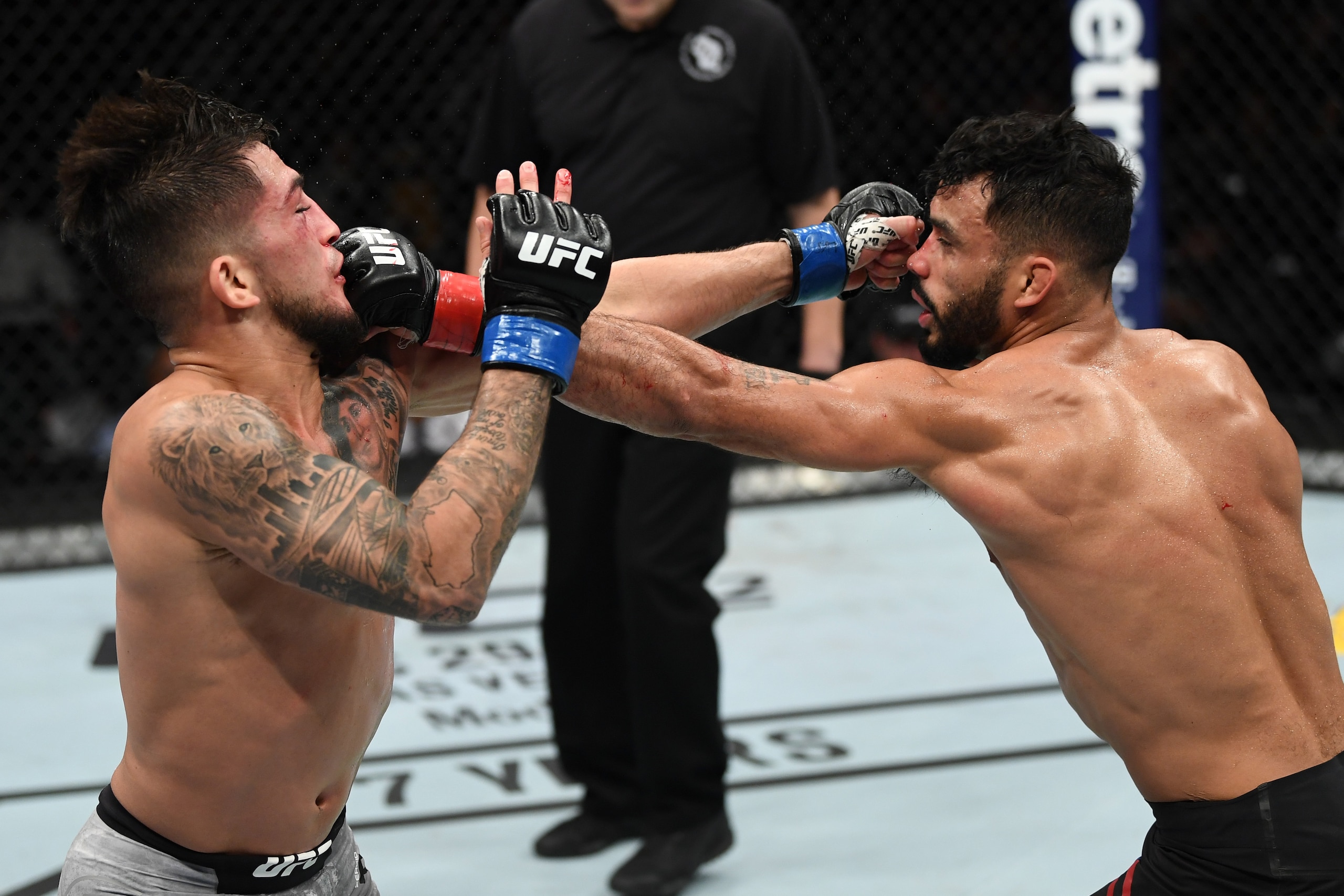 MILWAUKEE, WISCONSIN - DECEMBER 15:  (L-R) Sergio Pettis and Rob Font exchange punches in their bantamweight bout during the UFC Fight Night event at Fiserv Forum on December 15, 2018 in Milwaukee, Wisconsin. (Photo by Jeff Bottari/Zuffa LLC/Zuffa LLC via