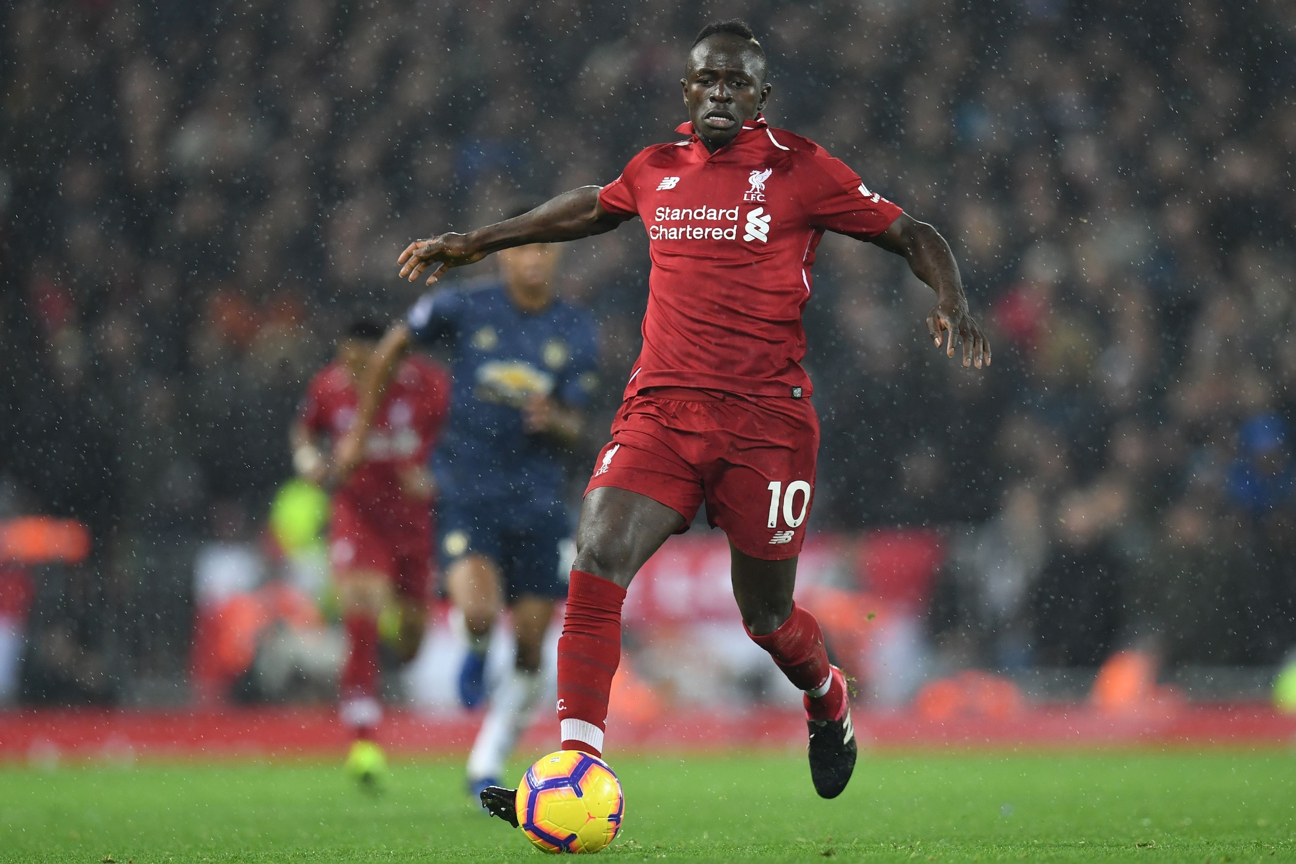Liverpool's Senegalese striker Sadio Mane runs with the ball during the English Premier League football match between Liverpool and Manchester United at Anfield in Liverpool, north west England on December 16, 2018. (Photo by Paul ELLIS / AFP) / RESTRICTE