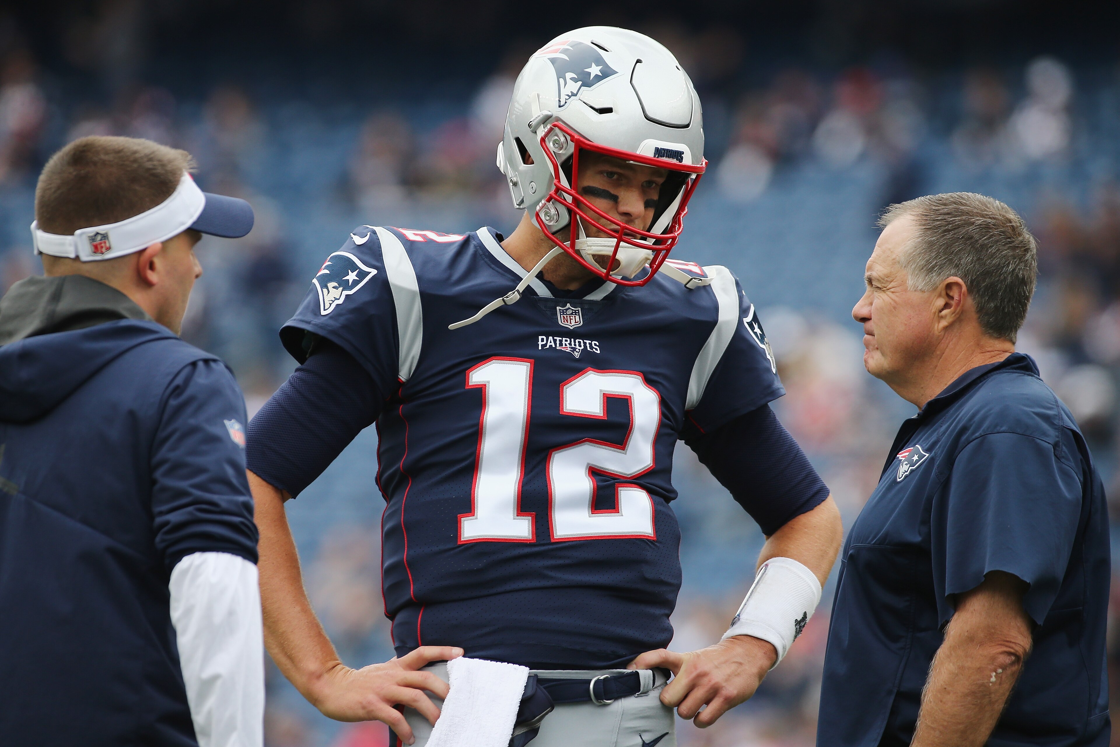 FOXBOROUGH, MA - SEPTEMBER 09:  Tom Brady #12 of the New England Patriots talks with offensive coordinator Josh McDaniels and head coach Bill Belichick before the game against the Houston Texans at Gillette Stadium on September 9, 2018 in Foxborough, Mass