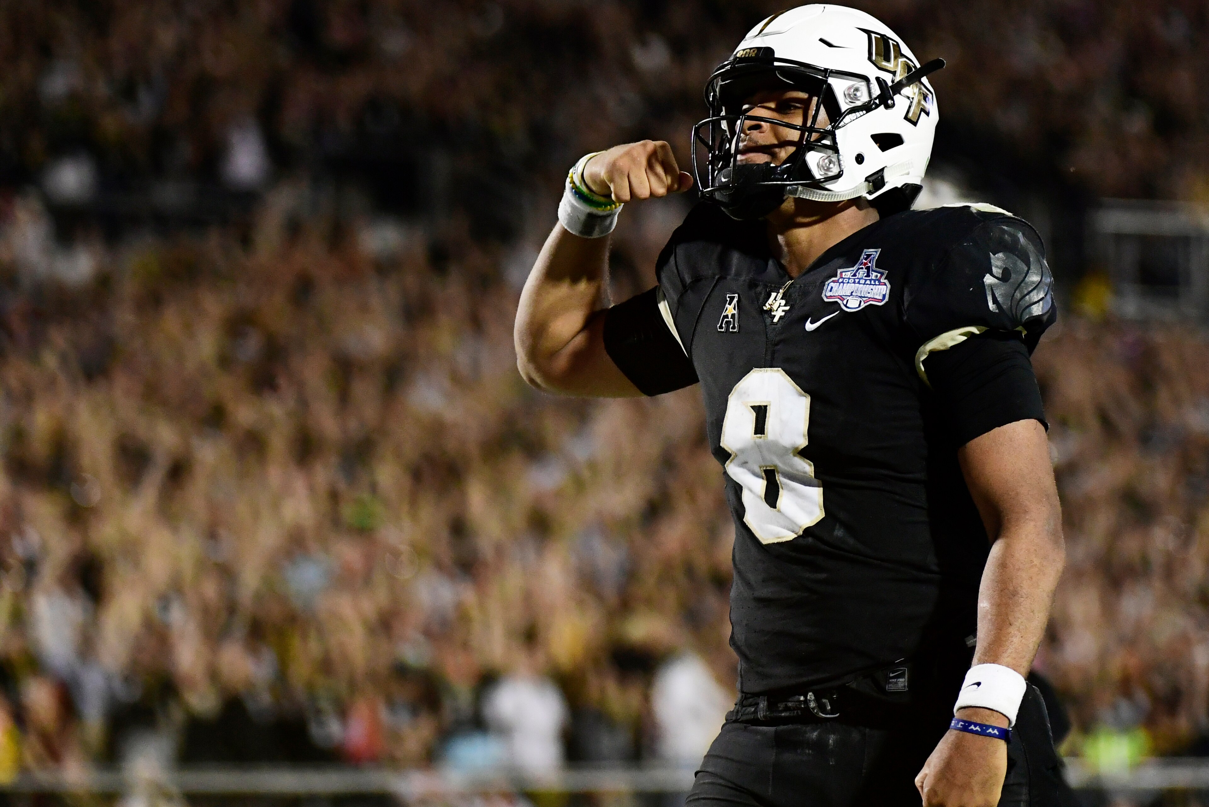 ORLANDO, FLORIDA - DECEMBER 01: Darriel Mack Jr. #8 of the UCF Knights celebrates after running in a touchdown in the fourth quarter of the American Athletic Championship against the Memphis Tigers at Spectrum Stadium on December 01, 2018 in Orlando, Flor