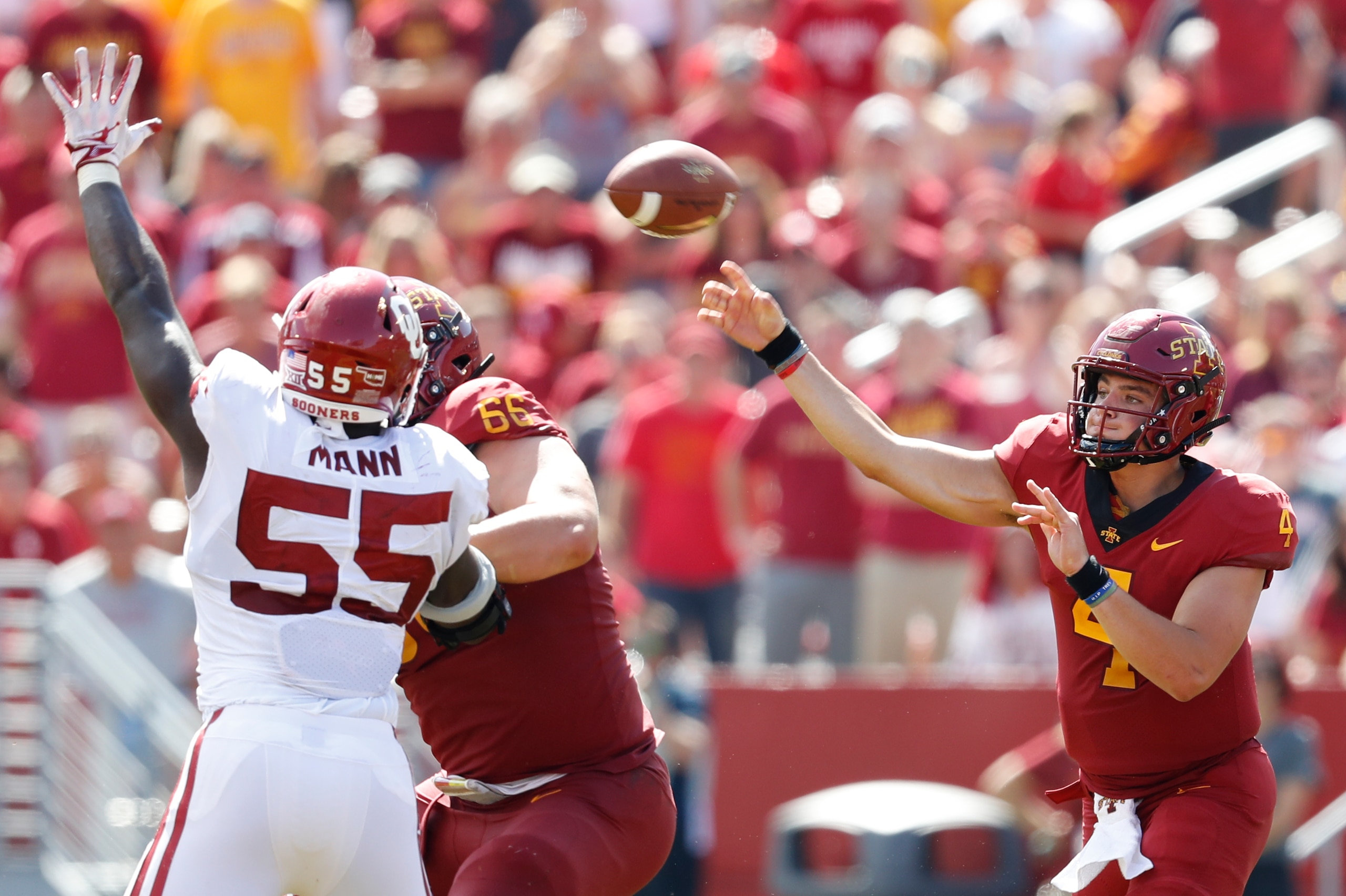 AMES, IA - SEPTEMBER 15: Quarterback Zeb Noland #4 of the Iowa State Cyclones passes the ball under pressure from defensive lineman Kenneth Mann #55 of the Oklahoma Sooners as offensive lineman Josh Knipfel #66 of the Iowa State Cyclones blocks in the sec