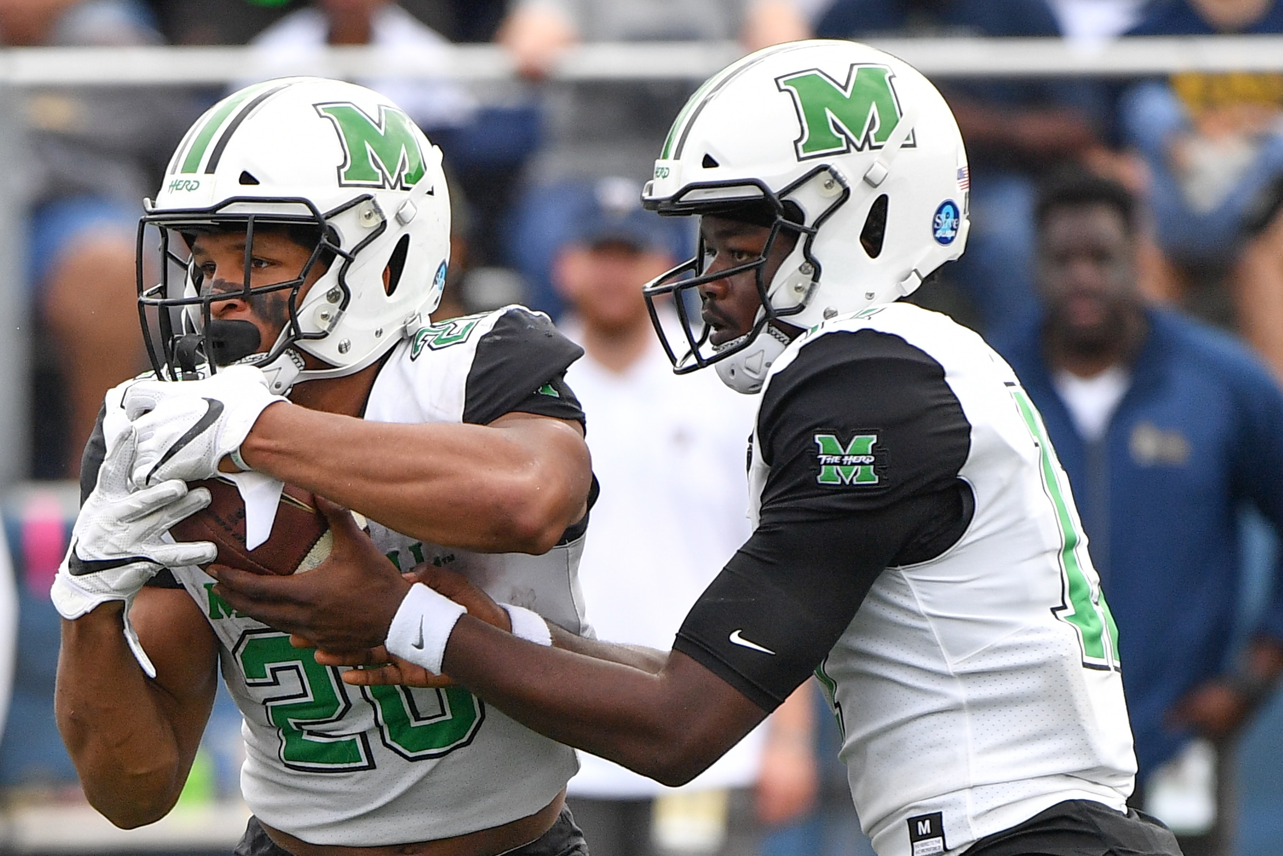 MIAMI, FL - NOVEMBER 24: Isaiah Green #17 hands the ball off to Brenden Knox #20 of the Marshall Thundering Herd in the second half against the FIU Golden Panthers at Ricardo Silva Stadium on November 24, 2018 in Miami, Florida. (Photo by Mark Brown/Getty
