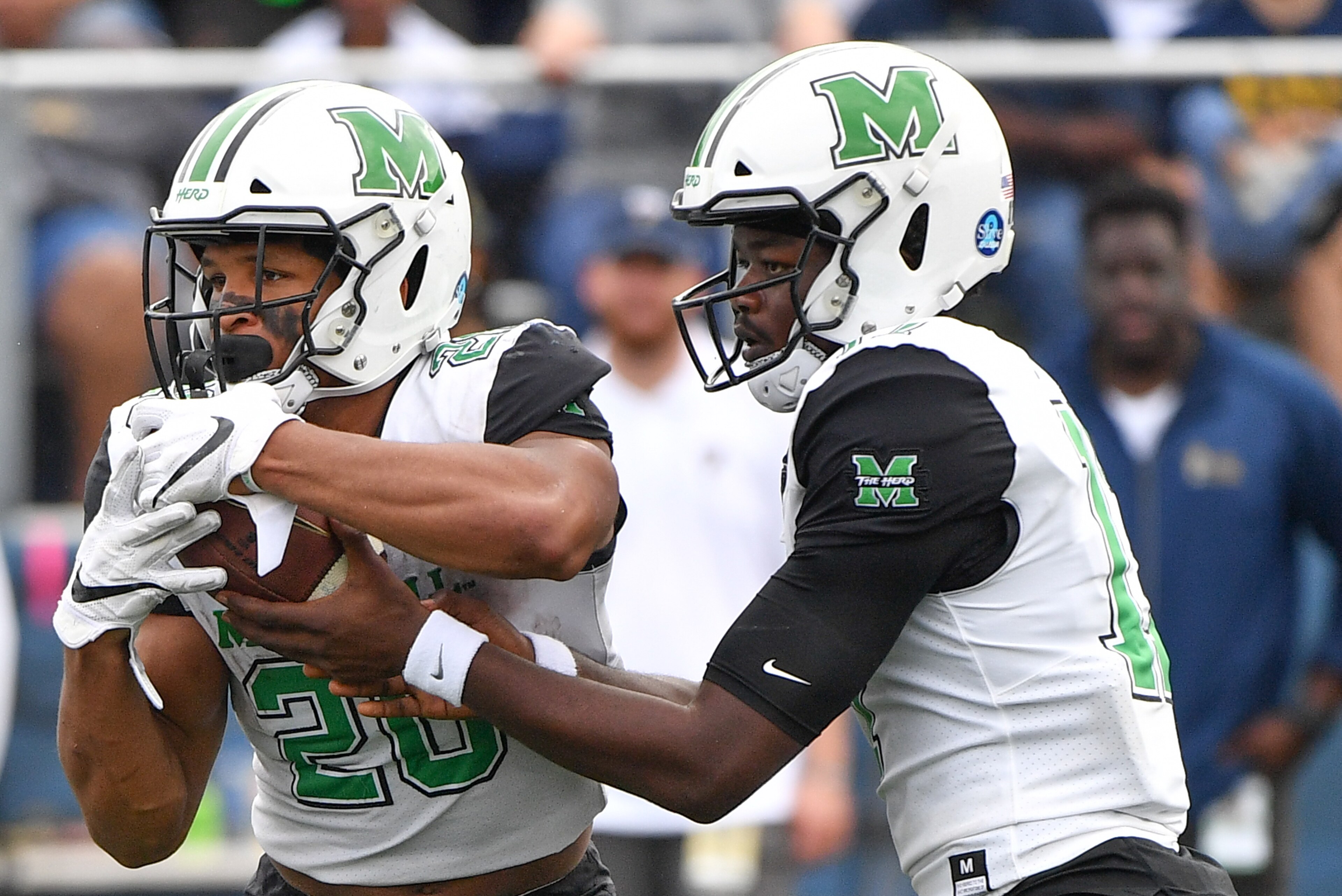 MIAMI, FL - NOVEMBER 24: Isaiah Green #17 hands the ball off to Brenden Knox #20 of the Marshall Thundering Herd in the second half against the FIU Golden Panthers at Ricardo Silva Stadium on November 24, 2018 in Miami, Florida. (Photo by Mark Brown/Getty