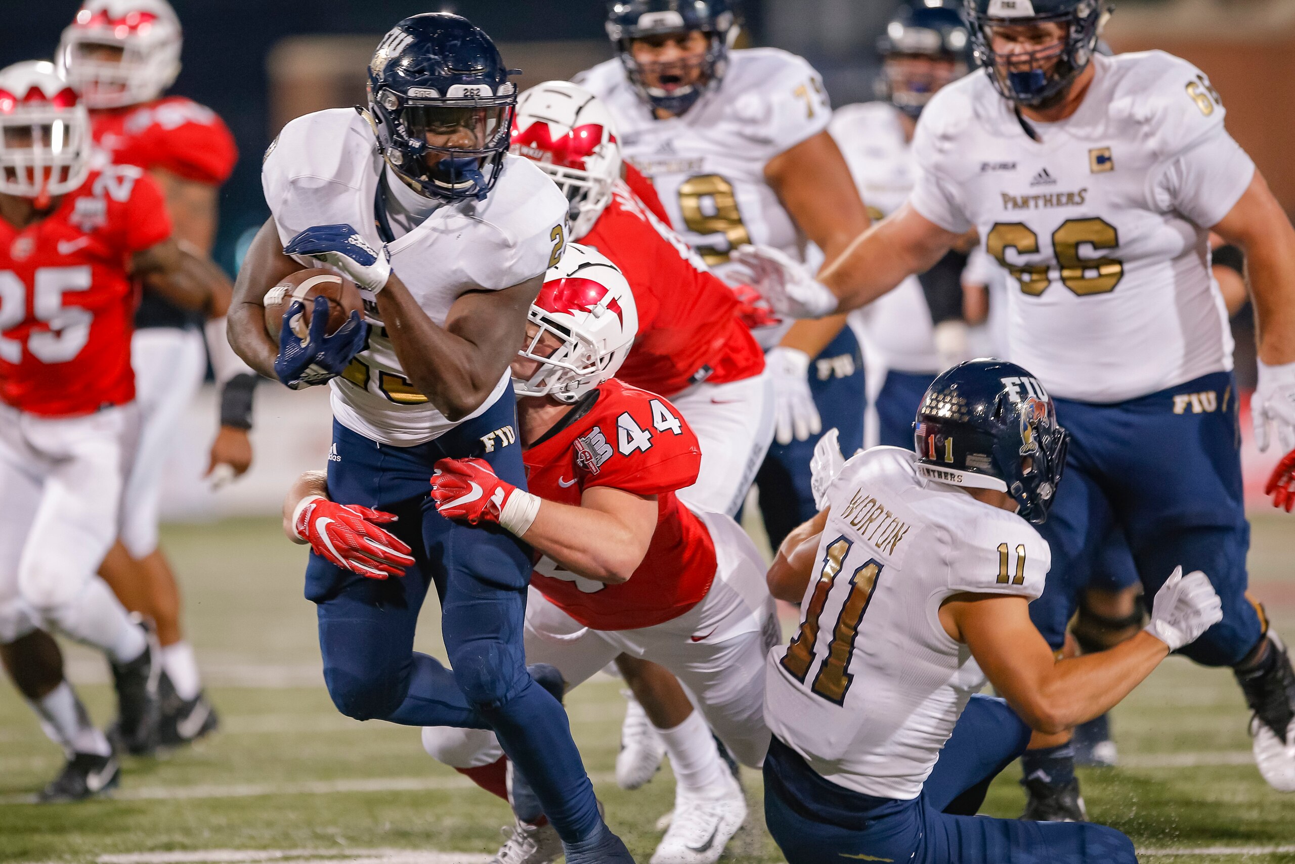BOWLING GREEN, KY - OCTOBER 27: Napoleon Maxwell #23 of the Fiu Golden Panthers runs the ball as Ben Holt #44 of the Western Kentucky Hilltoppers makes the tackle from behind on October 27, 2018 in Bowling Green, Kentucky. (Photo by Michael Hickey/Getty I