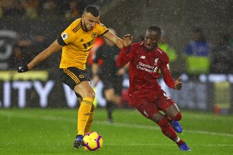 Wolverhampton Wanderers' Moroccan midfielder Romain Saiss (L) vies with Liverpool's Guinean midfielder Naby Keita (R) during the English Premier League football match between Wolverhampton Wanderers and Liverpool at the Molineux stadium in Wolverhampton, 