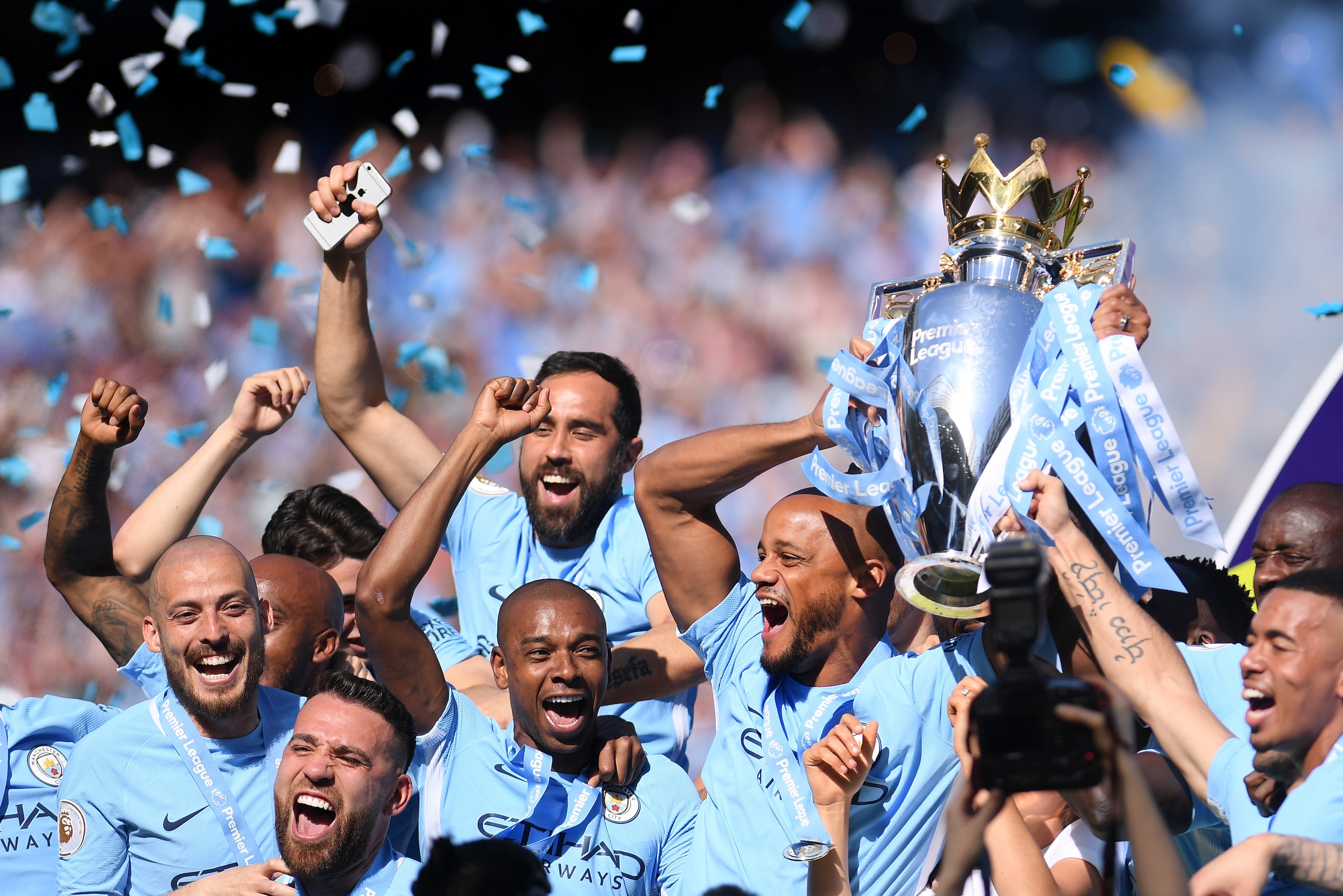 MANCHESTER, ENGLAND - MAY 06:  Vincent Kompany of Manchester City lifts the Premier League Trophy alongside David Silva, Nicolas Otamendi and Fernandinho as Manchester City celebrate winning the Premier League Title during the Premier League match between
