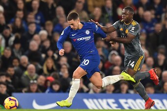 Chelsea's Belgian midfielder Eden Hazard (L) vies with Leicester City's French midfielder Nampalys Mendy (R) during the English Premier League football match between Chelsea and Leicester City at Stamford Bridge in London on December 22, 2018. (Photo by G