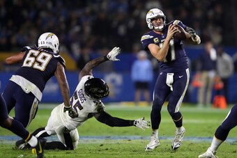 CARSON, CA - DECEMBER 22:  Sam Tevi #69 blocks as Philip Rivers #17 of the Los Angeles Chargers eludes a tackle by Terrell Suggs #55 of the Baltimore Ravens during the second half of a game at StubHub Center on December 22, 2018 in Carson, California.  (P