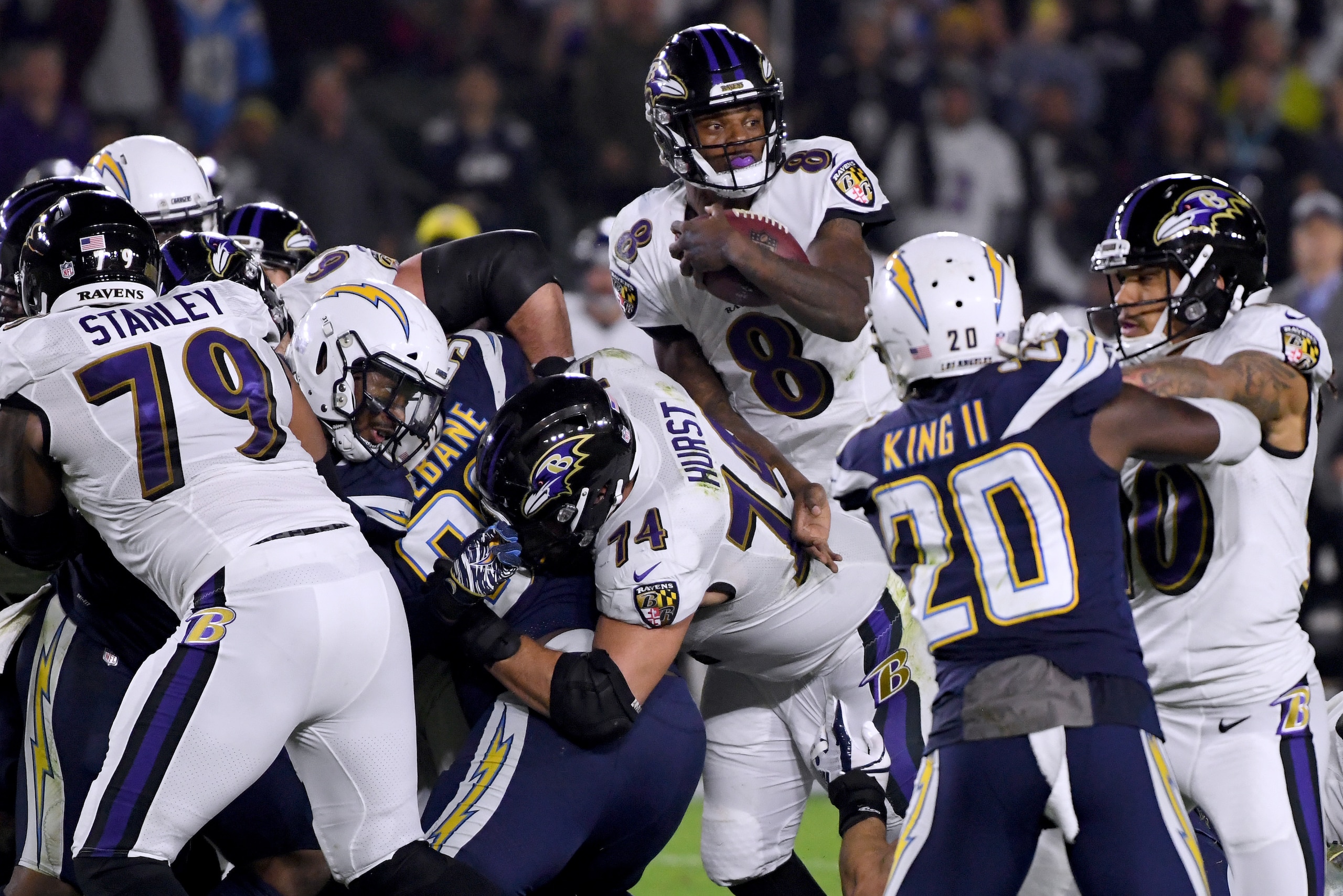 CARSON, CALIFORNIA - DECEMBER 22:   Lamar Jackson #8 of the Baltimore Ravens extends the ball on his keeper for a first down during the first quarter against the Los Angeles Chargers at StubHub Center on December 22, 2018 in Carson, California. (Photo by 