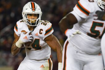 BLACKSBURG, VA - NOVEMBER 17: Running back Travis Homer #24 of the Miami Hurricanes carries the ball against the Virginia Tech Hokies in the second half at Lane Stadium on November 17, 2018 in Blacksburg, Virginia. (Photo by Michael Shroyer/Getty Images)