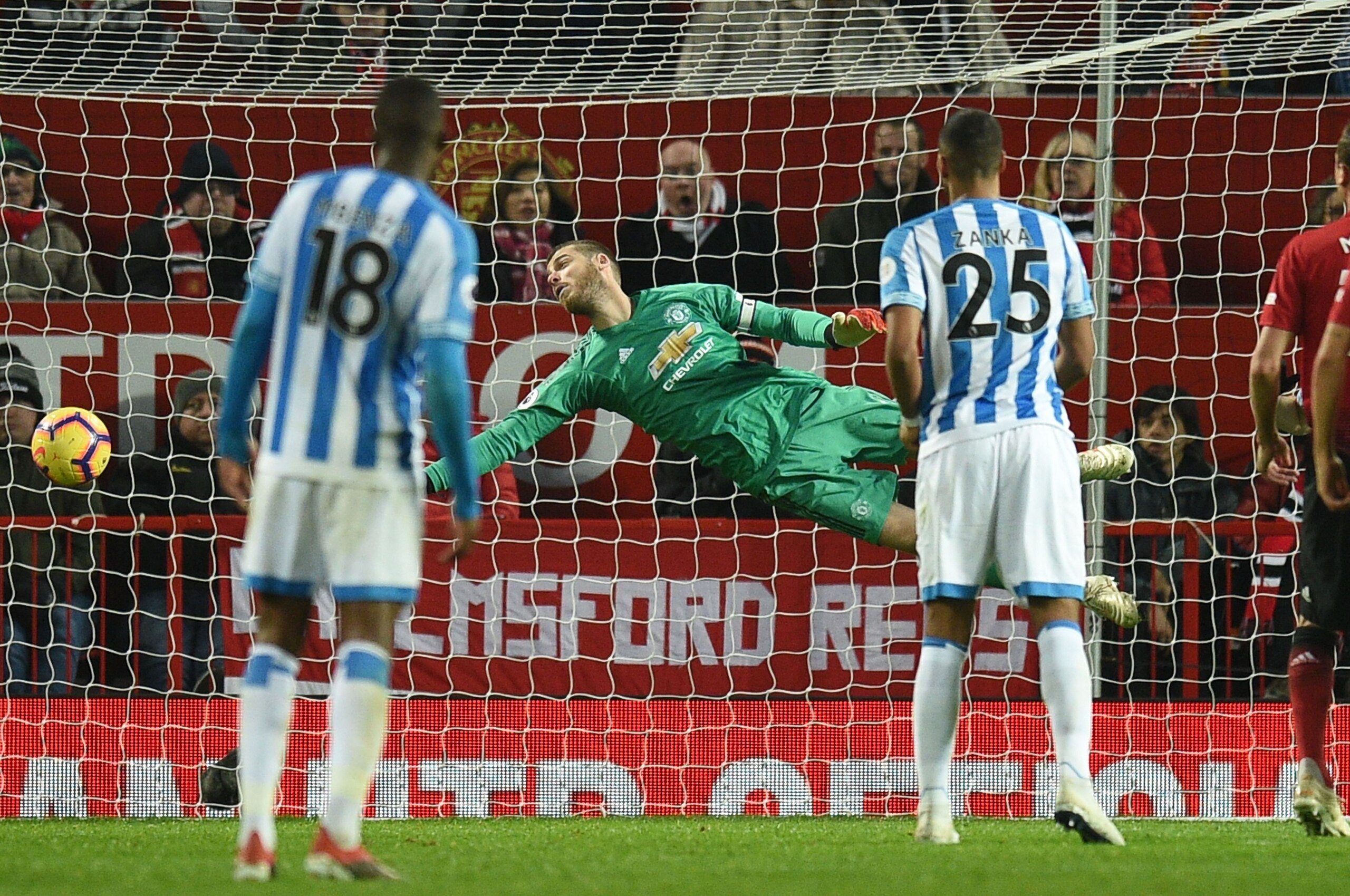 Manchester United's Spanish goalkeeper David de Gea makes a save during the English Premier League football match between Manchester United and Huddersfield Town at Old Trafford in Manchester, north west England, on December 26, 2018. (Photo by Oli SCARFF