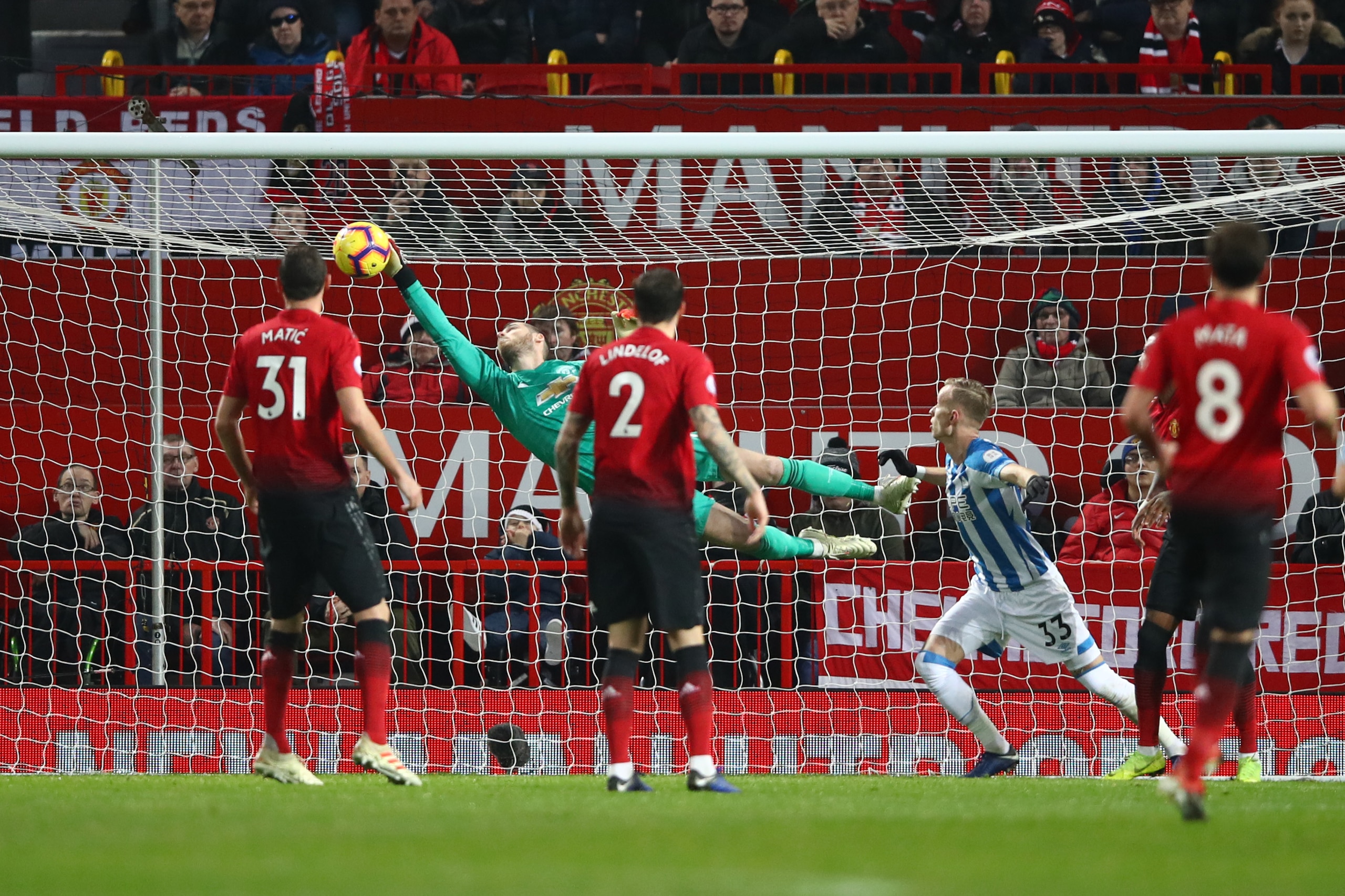 MANCHESTER, ENGLAND - DECEMBER 26:  David De Gea of Manchester United saves a shot during the Premier League match between Manchester United and Huddersfield Town at Old Trafford on December 26, 2018 in Manchester, United Kingdom.  (Photo by Clive Brunski