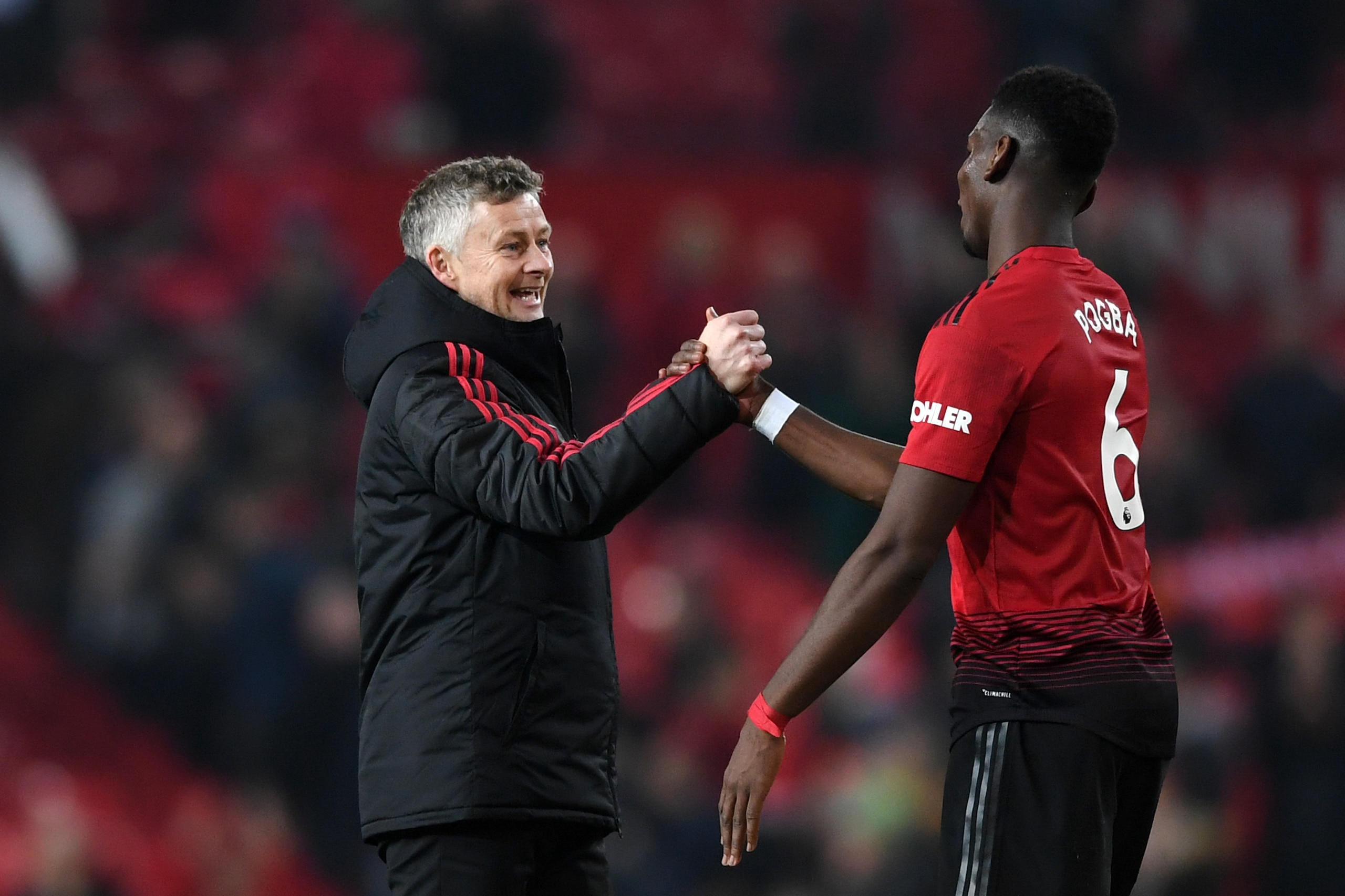 MANCHESTER, ENGLAND - DECEMBER 26:  Ole Gunnar Solskjaer, Interim Manager of Manchester United and Paul Pogba of Manchester United celebrate following their sides victory in the Premier League match between Manchester United and Huddersfield Town at Old T