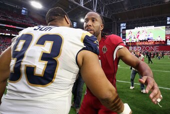 GLENDALE, ARIZONA - DECEMBER 23:  Wide receiver Larry Fitzgerald #11 of the Arizona Cardinals talks with nose tackle Ndamukong Suh #93 of the Los Angeles Rams following the NFL game at State Farm Stadium on December 23, 2018 in Glendale, Arizona. The Rams