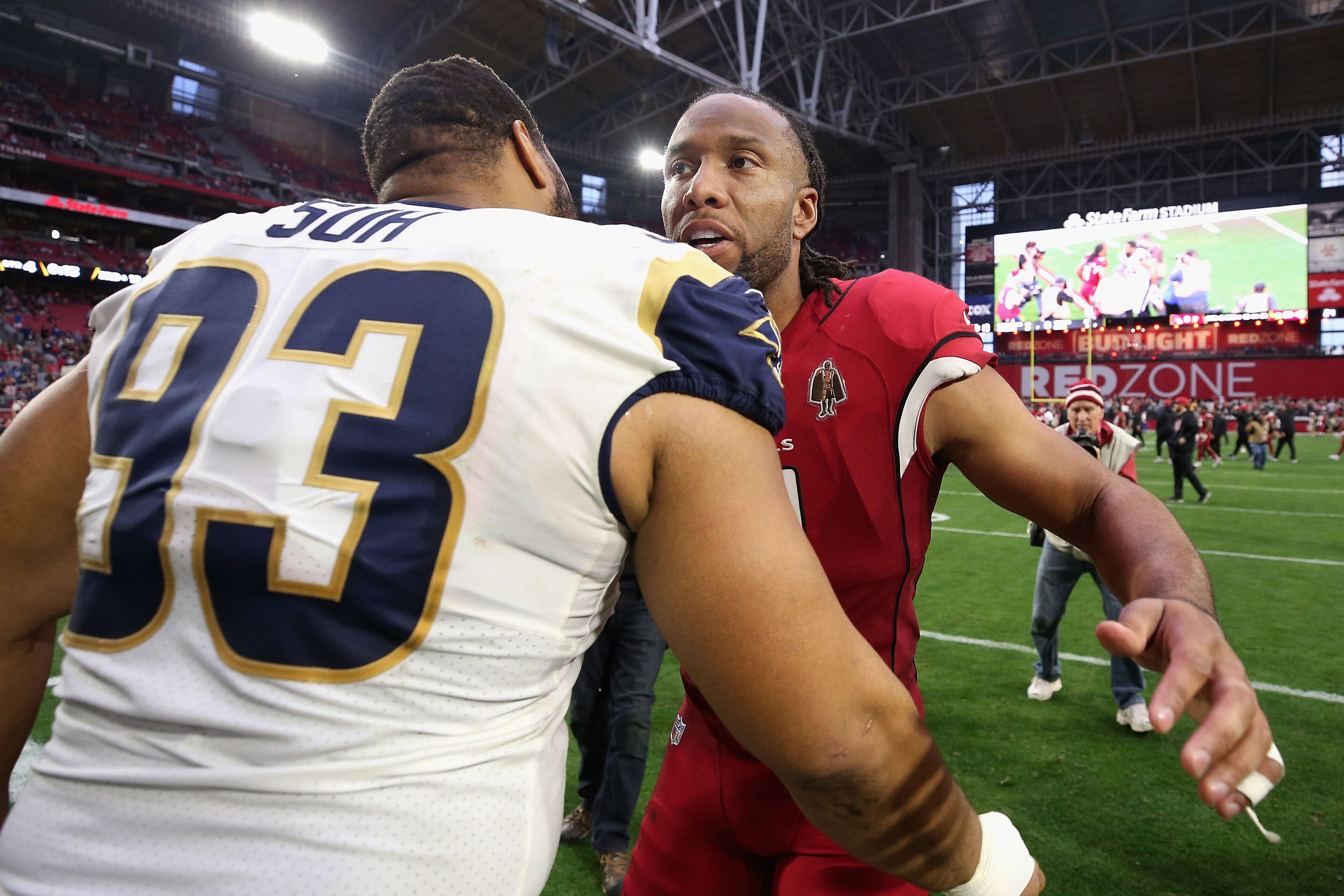 GLENDALE, ARIZONA - DECEMBER 23: Wide receiver Larry Fitzgerald #11 of the Arizona Cardinals talks with nose tackle Ndamukong Suh #93 of the Los Angeles Rams following the NFL game at State Farm Stadium on December 23, 2018 in Glendale, Arizona. The Rams GLENDALE, ARIZONA - DECEMBER 23: Wide receiver Larry Fitzgerald #11 of the Arizona Cardinals talks with nose tackle Ndamukong Suh #93 of the Los Angeles Rams following the NFL game at State Farm Stadium on December 23, 2018 in Glendale, Arizona. The Rams