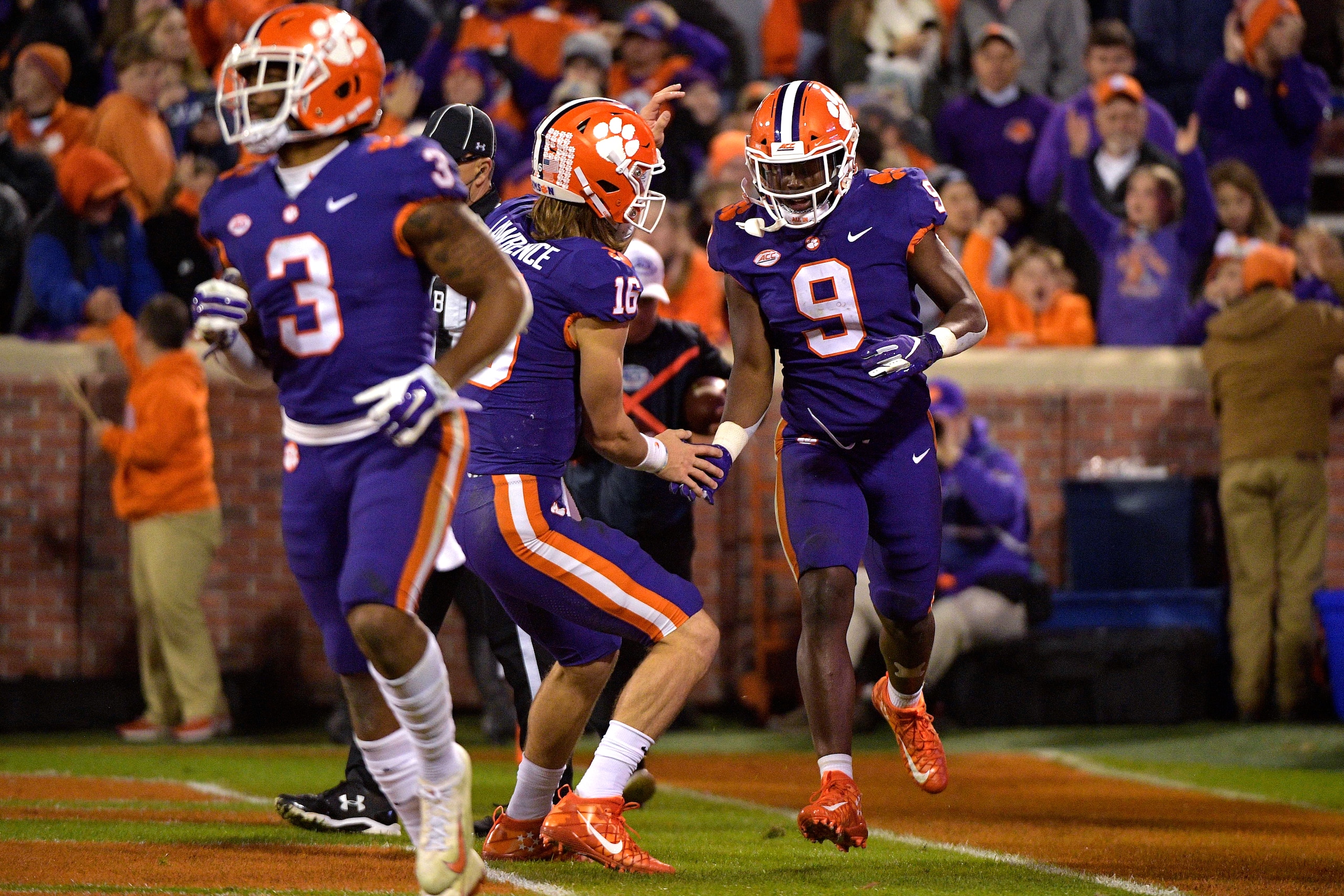 CLEMSON, SC - NOVEMBER 17: Trevor Lawrence #16 and Travis Etienne #9 of the Clemson Tigers celebrate following a 27-yard touchdown run by Etienne during their game against the Duke Blue Devils at Clemson Memorial Stadium on November 17, 2018 in Clemson, S