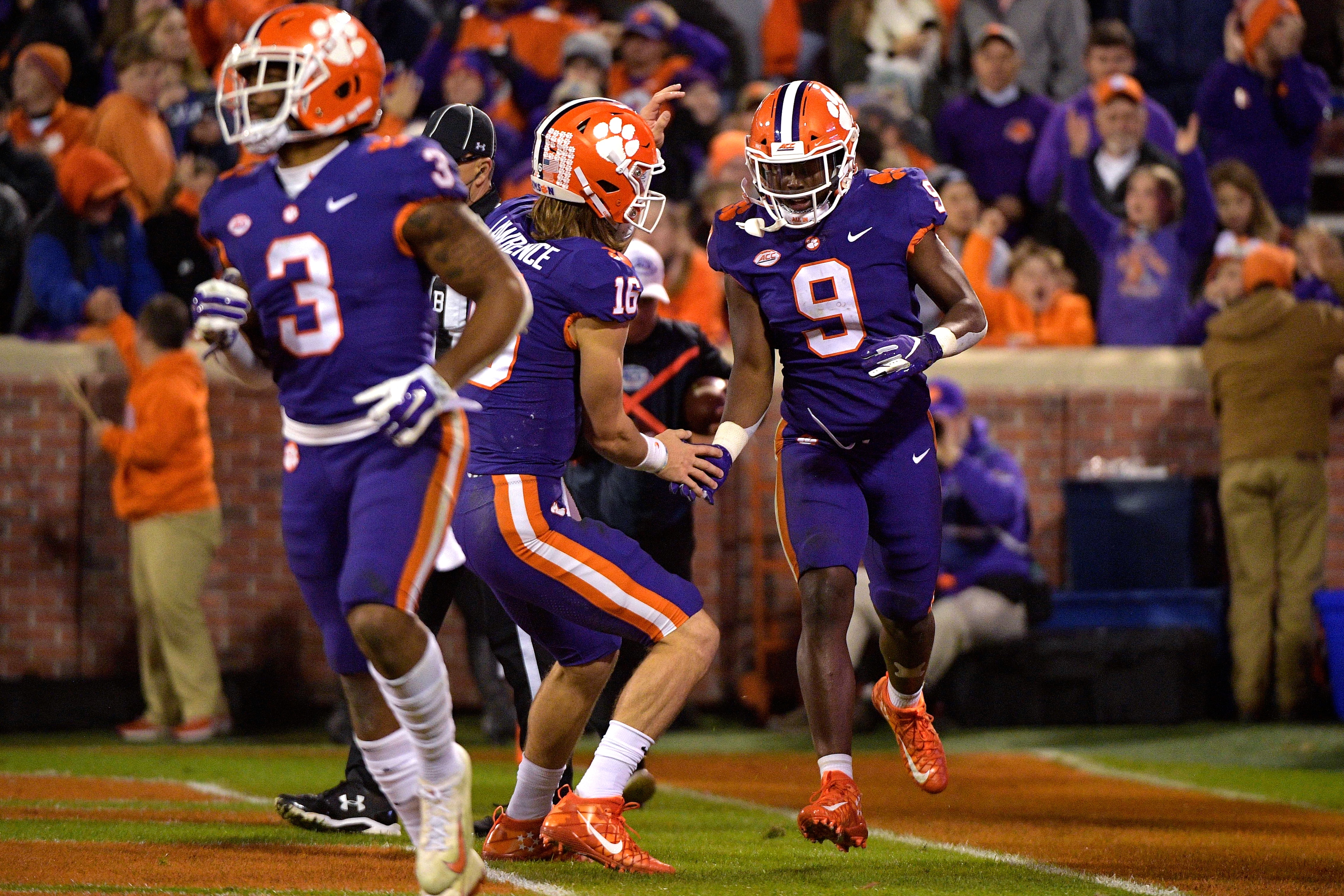 CLEMSON, SC - NOVEMBER 17: Trevor Lawrence #16 and Travis Etienne #9 of the Clemson Tigers celebrate following a 27-yard touchdown run by Etienne during their game against the Duke Blue Devils at Clemson Memorial Stadium on November 17, 2018 in Clemson, S