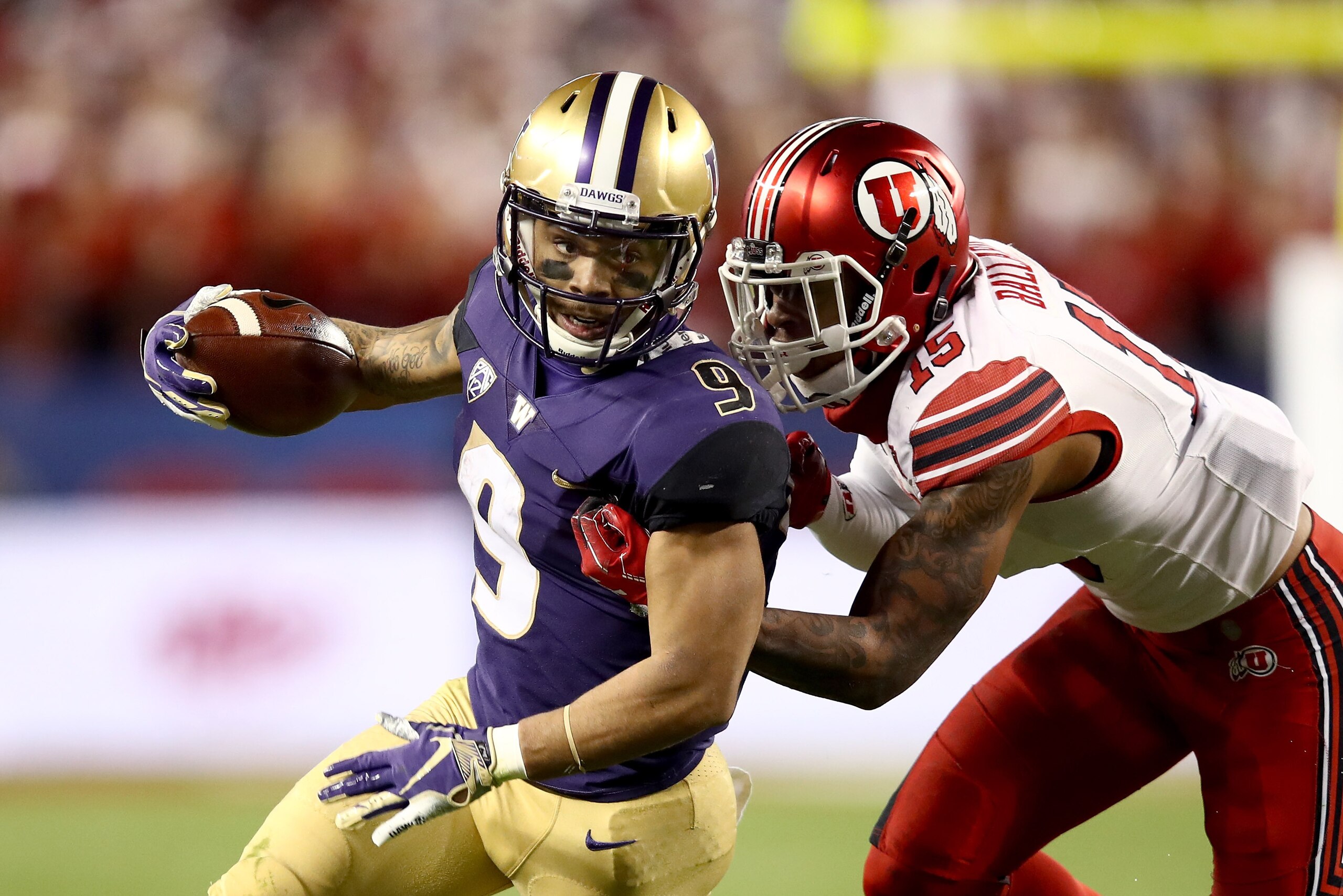 SANTA CLARA, CA - NOVEMBER 30:  Myles Gaskin #9 of the Washington Huskies is tackled by Corrion Ballard #15 of the Utah Utes during the Pac 12 Championship game at Levi's Stadium on November 30, 2018 in Santa Clara, California.  (Photo by Ezra Shaw/Getty 
