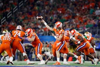 ARLINGTON, TEXAS - DECEMBER 29: Trevor Lawrence #16 of the Clemson Tigers throws a pass in the second half against the Notre Dame Fighting Irish during the College Football Playoff Semifinal Goodyear Cotton Bowl Classic at AT&T Stadium on December 29, 201