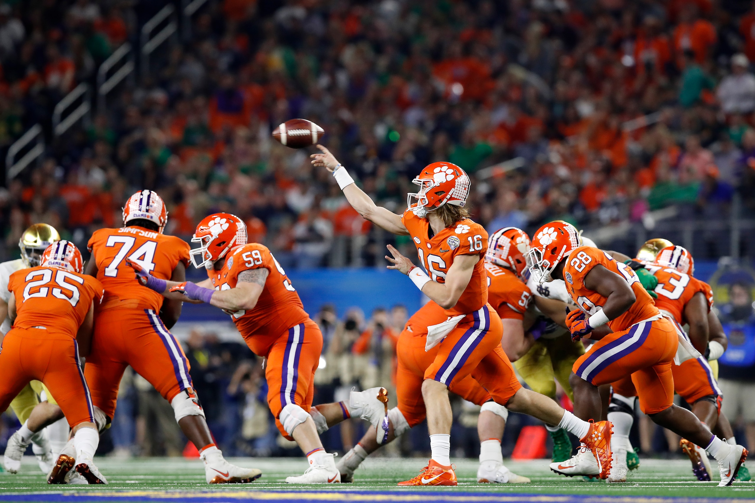 ARLINGTON, TEXAS - DECEMBER 29: Trevor Lawrence #16 of the Clemson Tigers throws a pass in the second half against the Notre Dame Fighting Irish during the College Football Playoff Semifinal Goodyear Cotton Bowl Classic at AT&T Stadium on December 29, 201