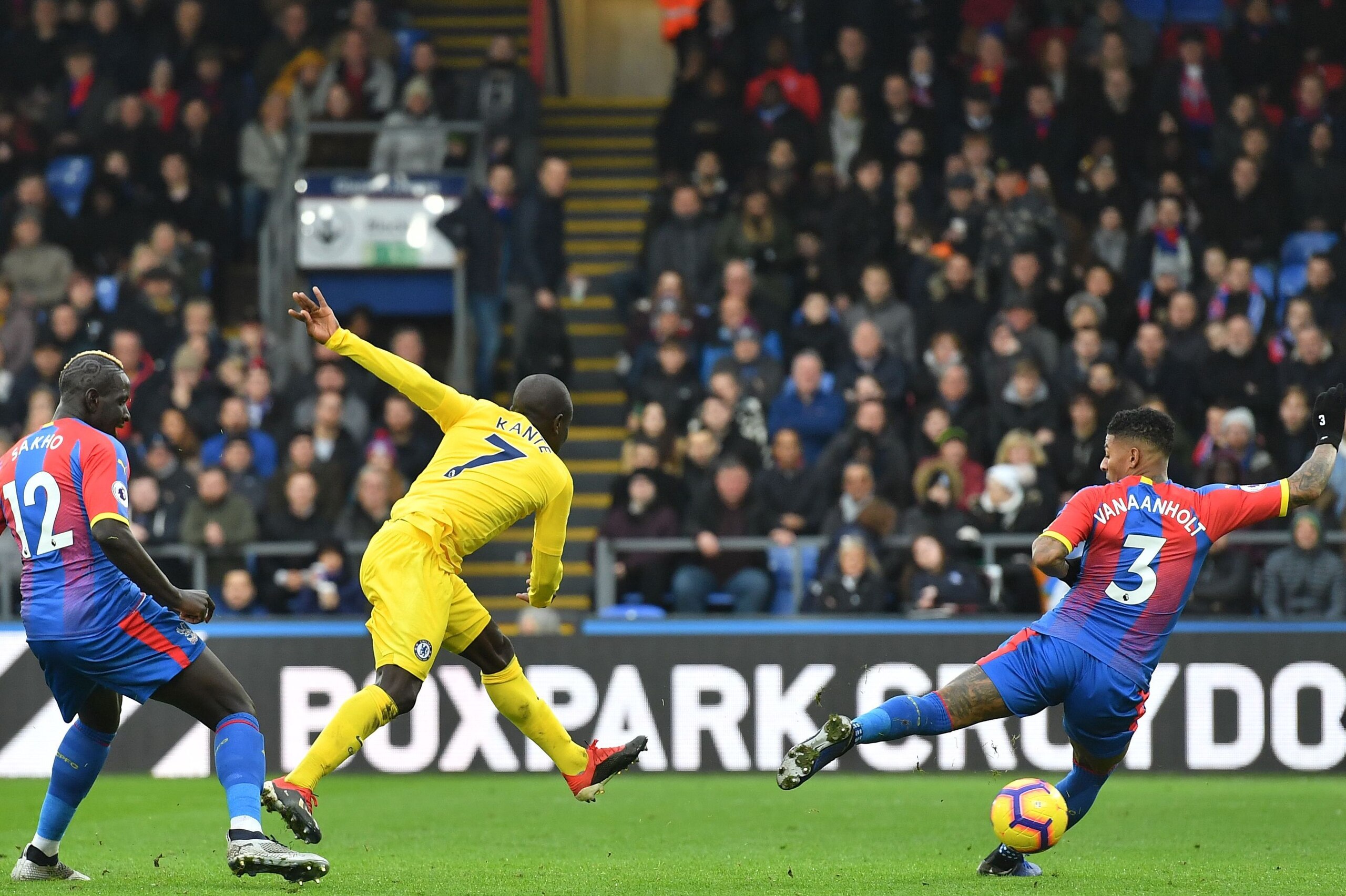 Chelsea's French midfielder N'Golo Kante (C) shoots past Crystal Palace's Dutch defender Patrick van Aanholt (R) to score the opening goal of the English Premier League football match between Crystal Palace and Chelsea at Selhurst Park in south London on 