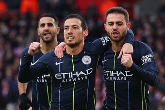 SOUTHAMPTON, ENGLAND - DECEMBER 30:  David Silva of Manchester City (21) celebrates after scoring his team's first goal with team mates Bernardo Silva and Riyad Mahrez during the Premier League match between Southampton FC and Manchester City at St Mary's