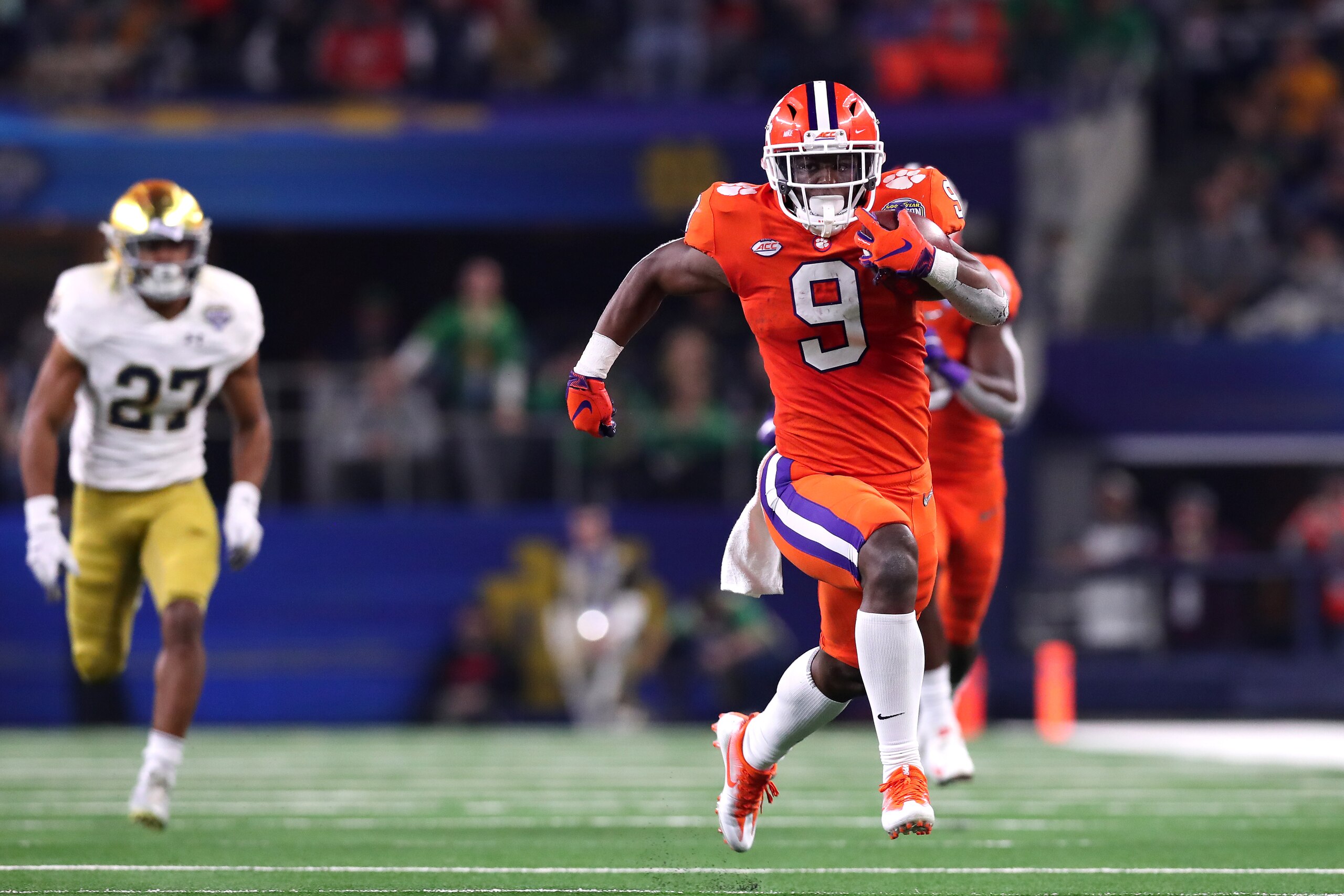 ARLINGTON, TEXAS - DECEMBER 29: Travis Etienne #9 of the Clemson Tigers runs for a 62 yard touchdown in the third quarter against the Notre Dame Fighting Irish during the College Football Playoff Semifinal Goodyear Cotton Bowl Classic at AT&T Stadium on D