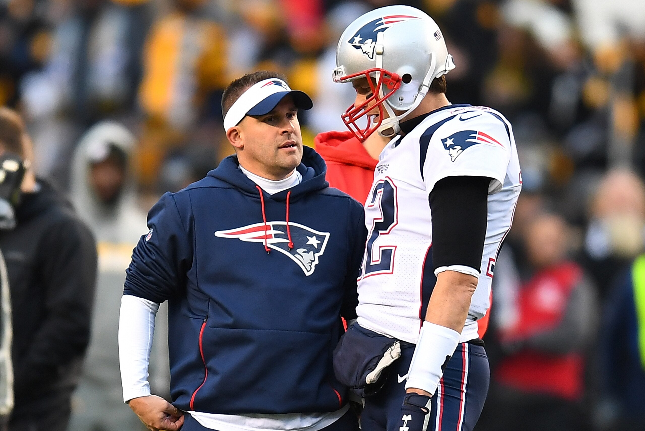 PITTSBURGH, PA - DECEMBER 16:  Tom Brady #12 of the New England Patriots talks with offensive coordinator Josh McDaniels during warmups prior to the game against the Pittsburgh Steelers at Heinz Field on December 16, 2018 in Pittsburgh, Pennsylvania. (Pho