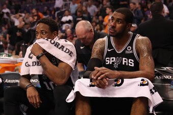 PHOENIX, AZ - NOVEMBER 14:  DeMar DeRozan #10 and LaMarcus Aldridge #12 of the San Antonio Spurs react on the bench during the second half of the NBA game against the Phoenix Suns at Talking Stick Resort Arena on November 14, 2018 in Phoenix, Arizona. NOT