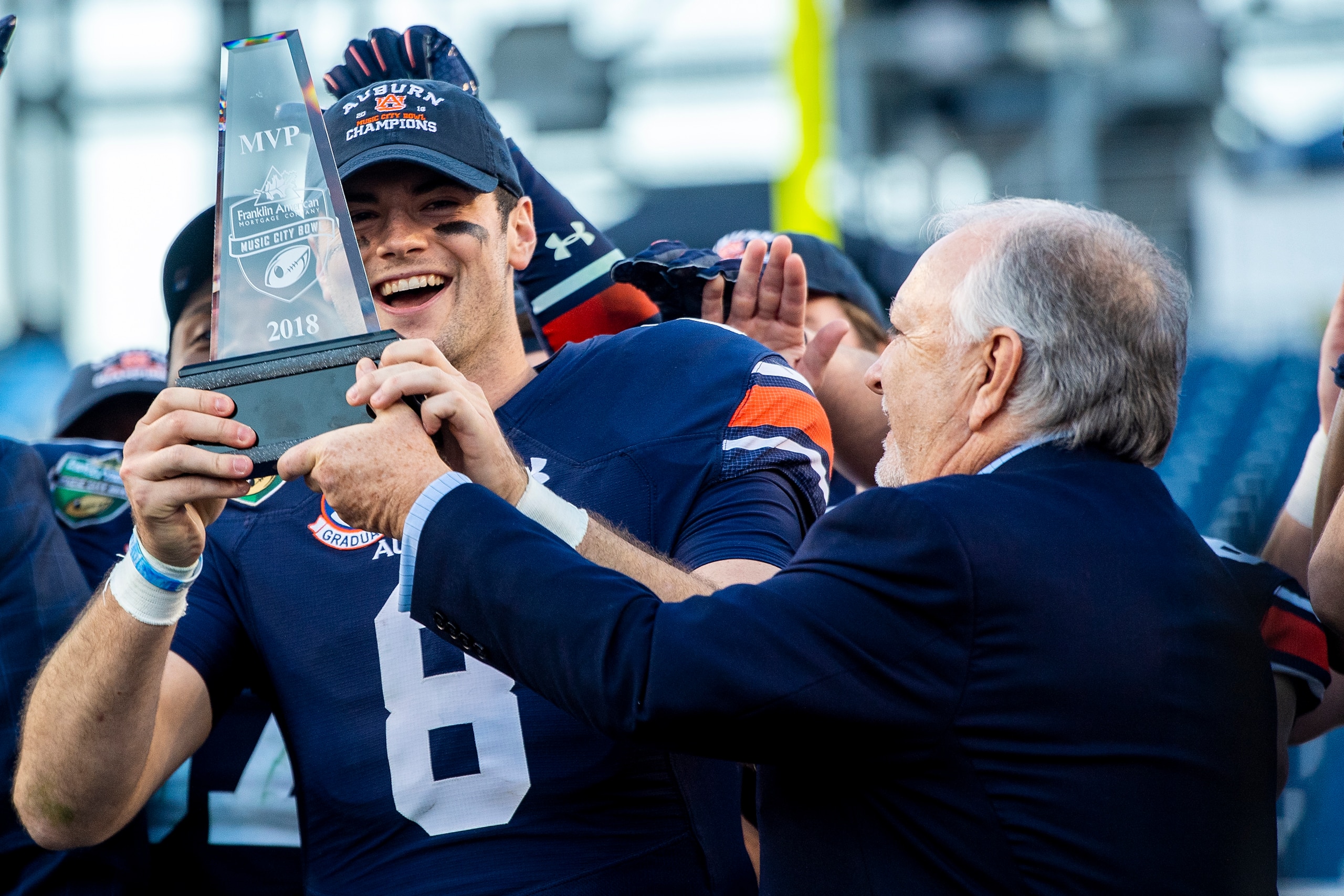 NASHVILLE, TN - DECEMBER 28: Jarrett Stidham #8 of the Auburn Tigers is awarded the Most Valuable Player award after defeating the Purdue Boilermakers at Nissan Stadium on December 28, 2018 in Nashville, Tennessee. (Photo by Timothy Nwachukwu/Getty Images