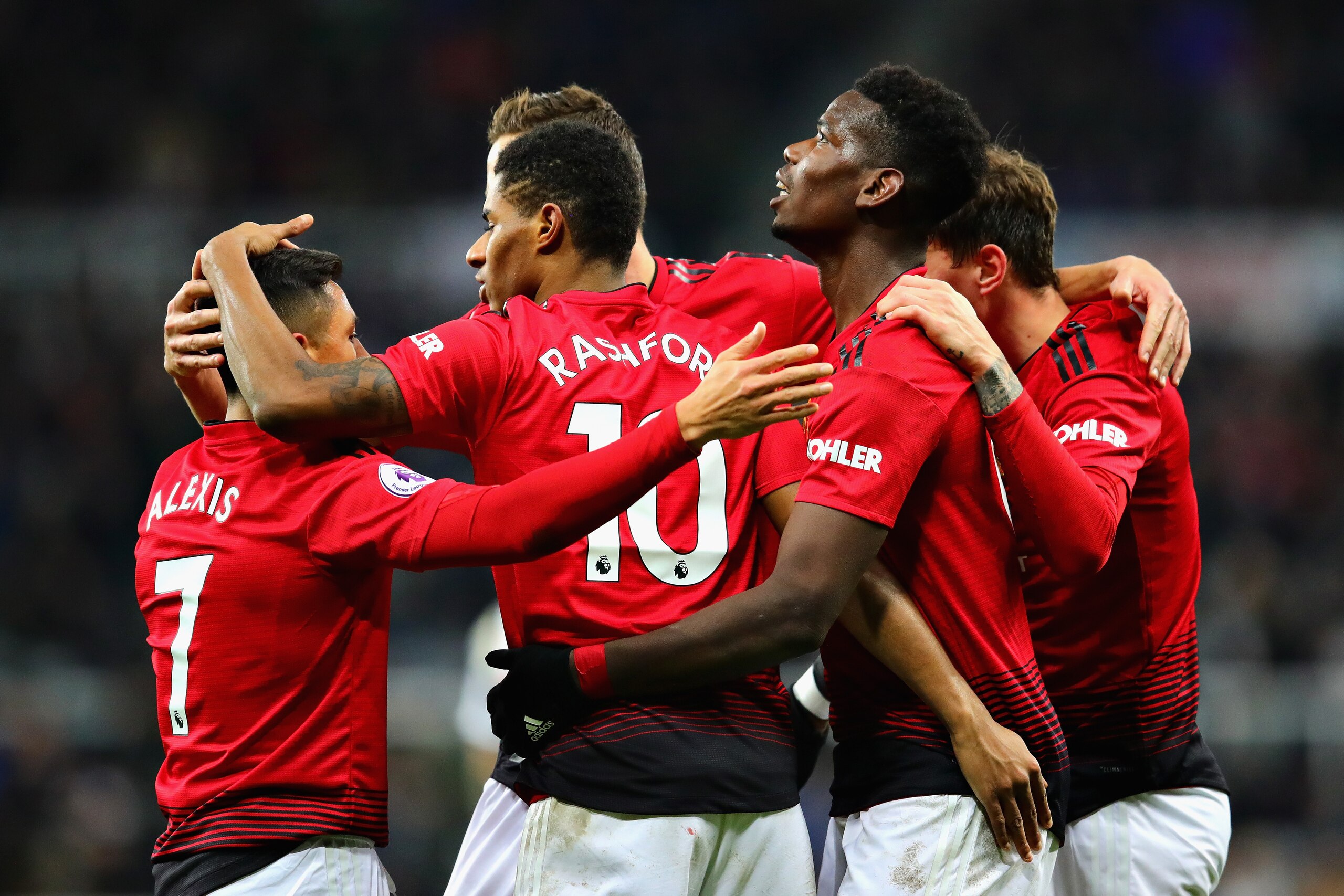 NEWCASTLE UPON TYNE, ENGLAND - JANUARY 02:  Marcus Rashford of Manchester United celebrates with his teammates after scoring his sides second goal during the Premier League match between Newcastle United and Manchester United at St. James Park on January 