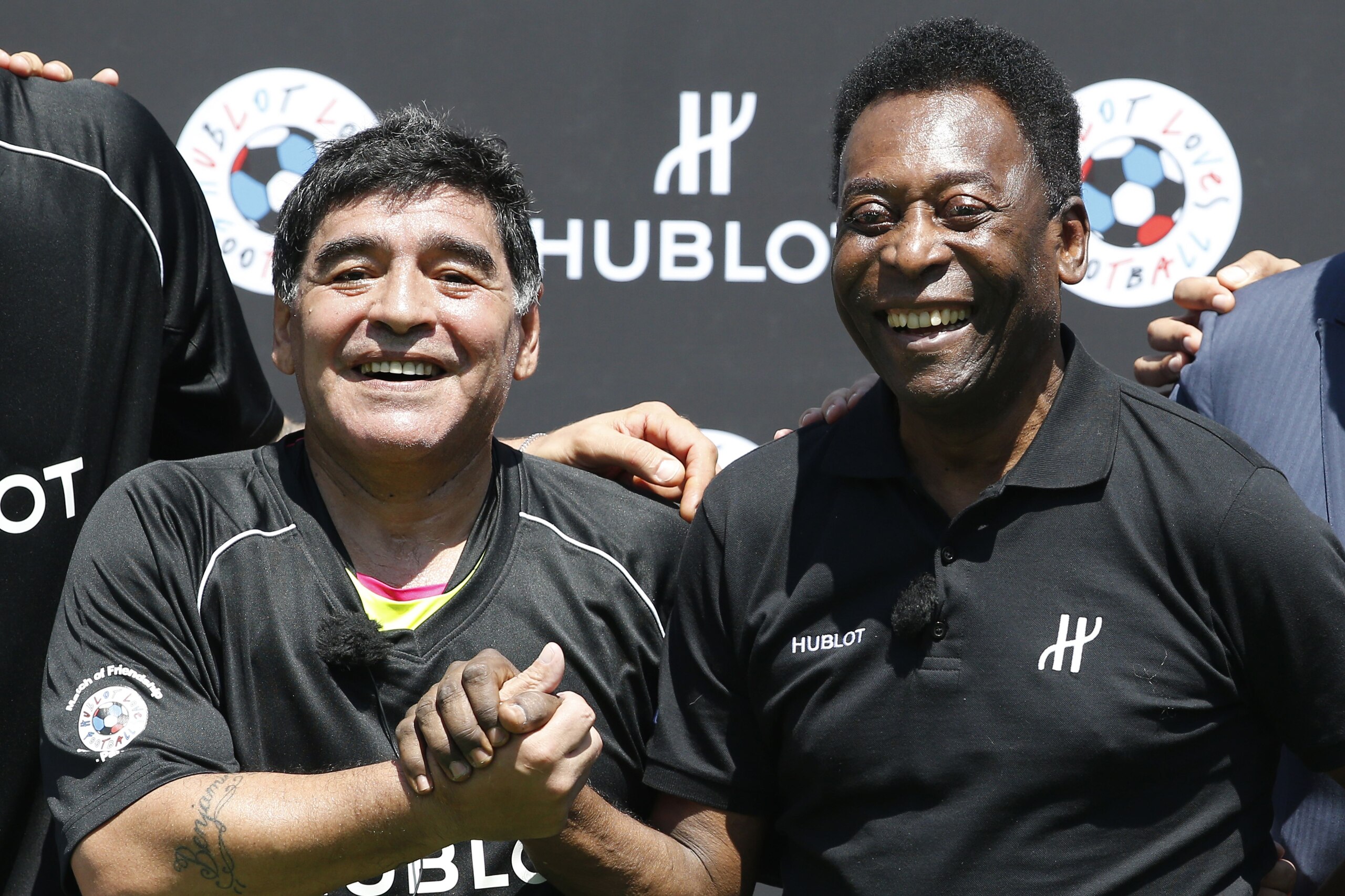 Former Argentinian football international Diego Maradona (L) and former Brazilian footballer Pele pose after a football match organised by Swiss luxury watchmaker Hublot at the Jardin du Palais Royal in Paris on June 9, 2016, on the eve of the Euro 2016 E