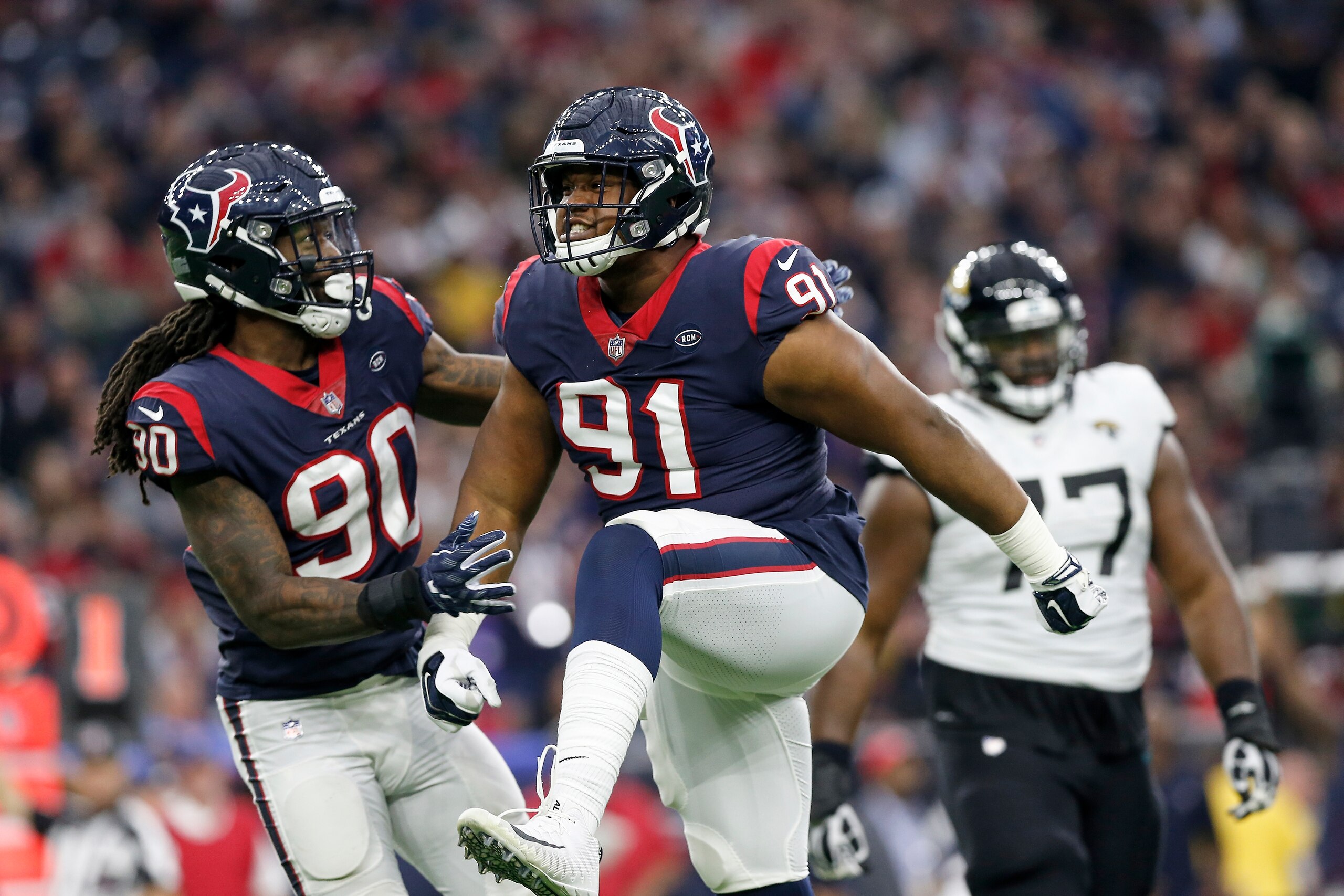 HOUSTON, TX - DECEMBER 30:  Carlos Watkins #91 of the Houston Texans celebrates after a sack in the fourth quarter against the Jacksonville Jaguars at NRG Stadium on December 30, 2018 in Houston, Texas.  (Photo by Tim Warner/Getty Images)