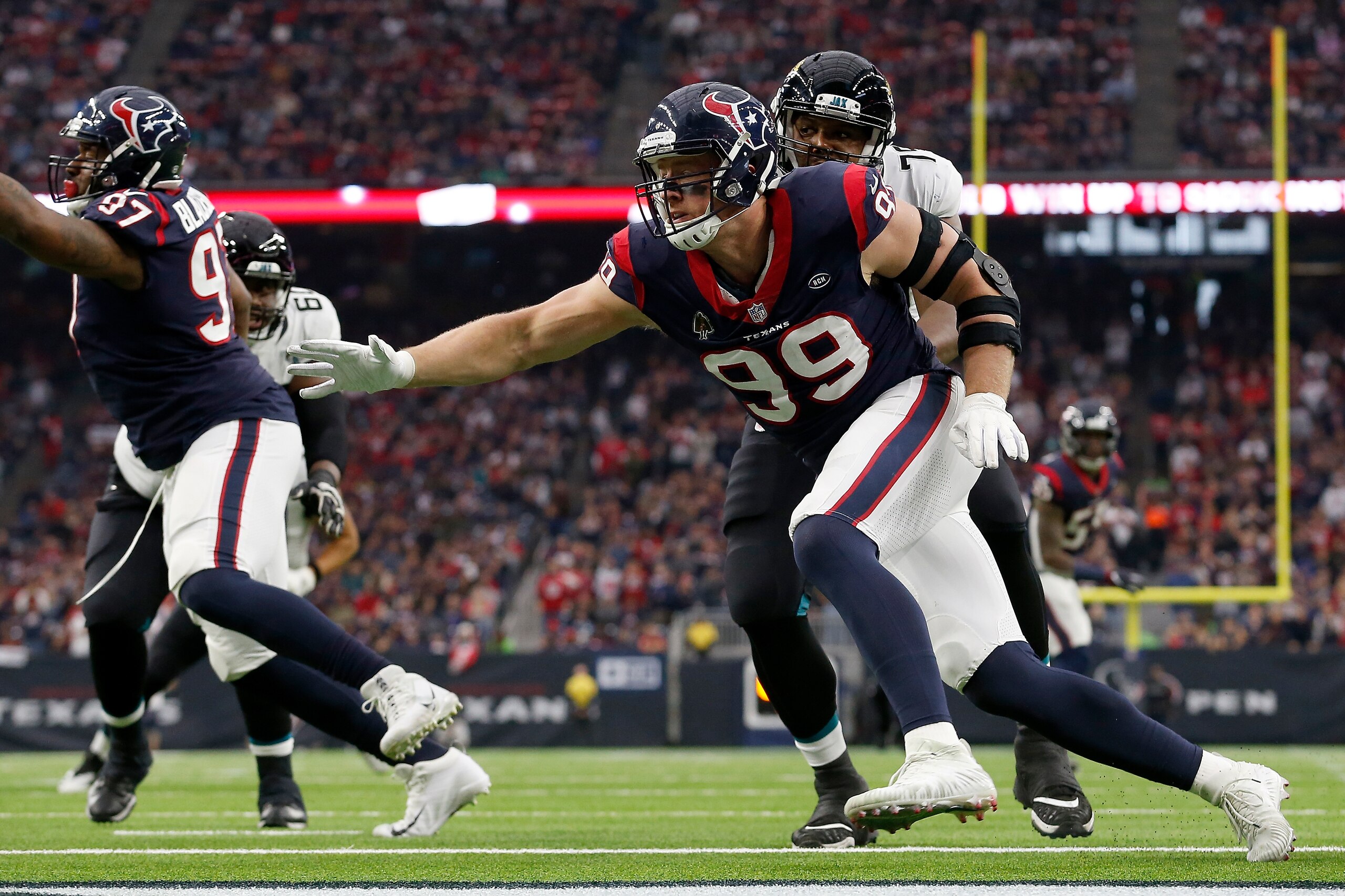 HOUSTON, TX - DECEMBER 30:  J.J. Watt #99 of the Houston Texans battles Corey Robinson #79 of the Jacksonville Jaguars in the second quarter at NRG Stadium on December 30, 2018 in Houston, Texas.  (Photo by Tim Warner/Getty Images)