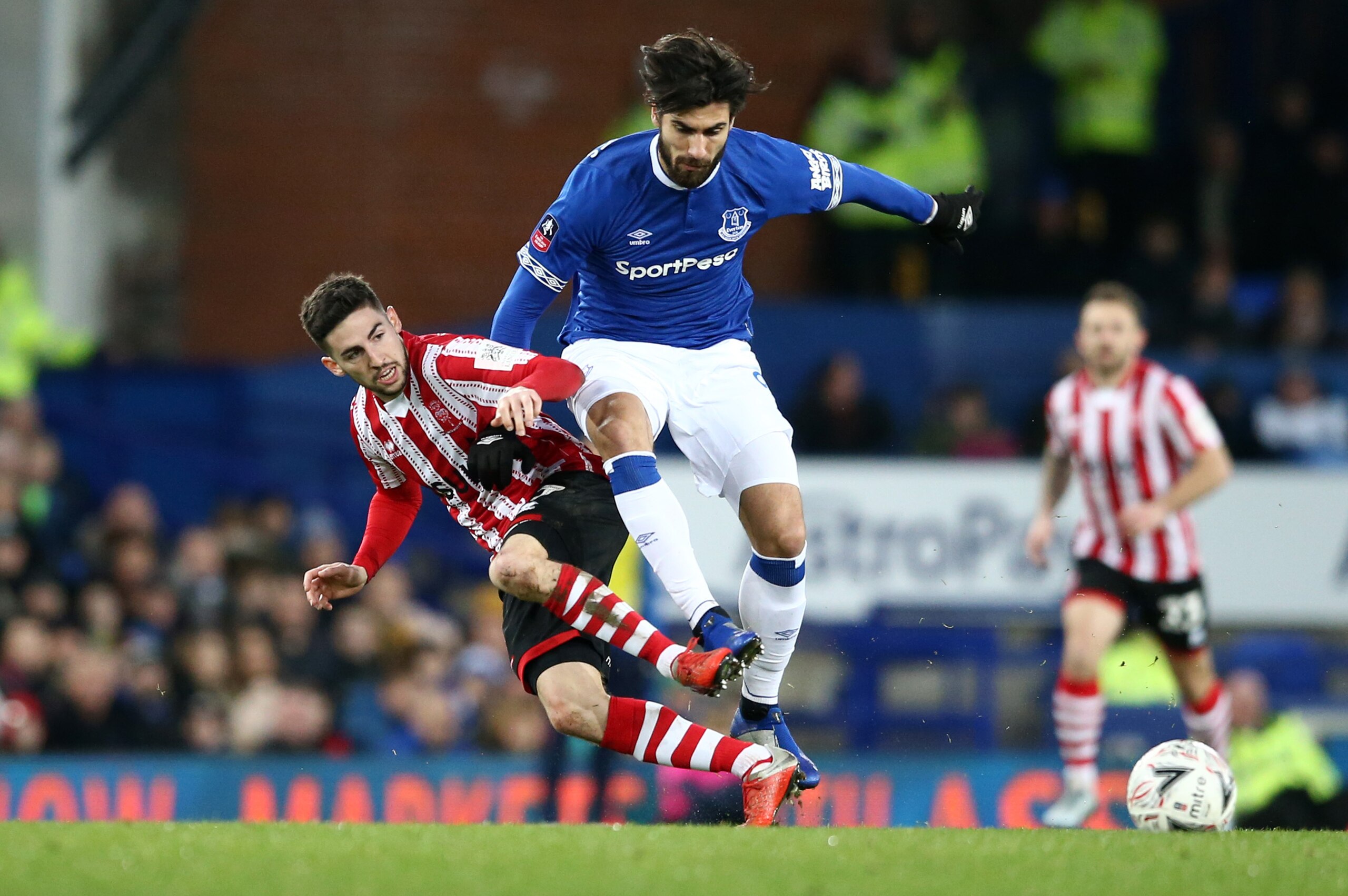 LIVERPOOL, ENGLAND - JANUARY 05:  Andre Gomes of Everton and Tom Pett of Lincoln City in action during the FA Cup Third Round match between Everton and Lincoln City at Goodison Park on January 5, 2019 in Liverpool, United Kingdom.  (Photo by Jan Kruger/Ge