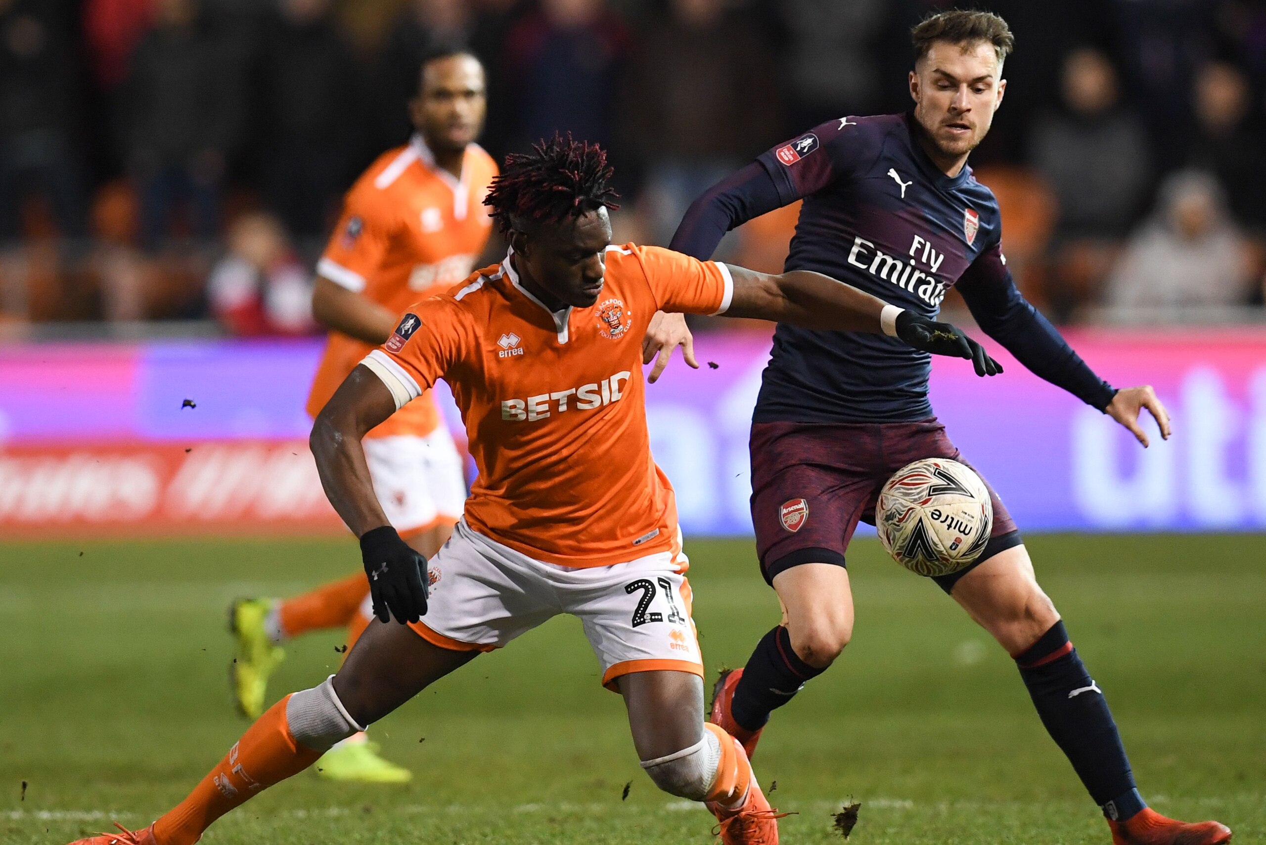 Blackpool's Ivory Coast striker Armand Gnanduillet (L) goes down in a challenge with Arsenal's Welsh midfielder Aaron Ramsey (R) during the English FA Cup third round football match between Blackpool and Arsenal at Bloomfield Road in Blackpool, north west Blackpool's Ivory Coast striker Armand Gnanduillet (L) goes down in a challenge with Arsenal's Welsh midfielder Aaron Ramsey (R) during the English FA Cup third round football match between Blackpool and Arsenal at Bloomfield Road in Blackpool, north west