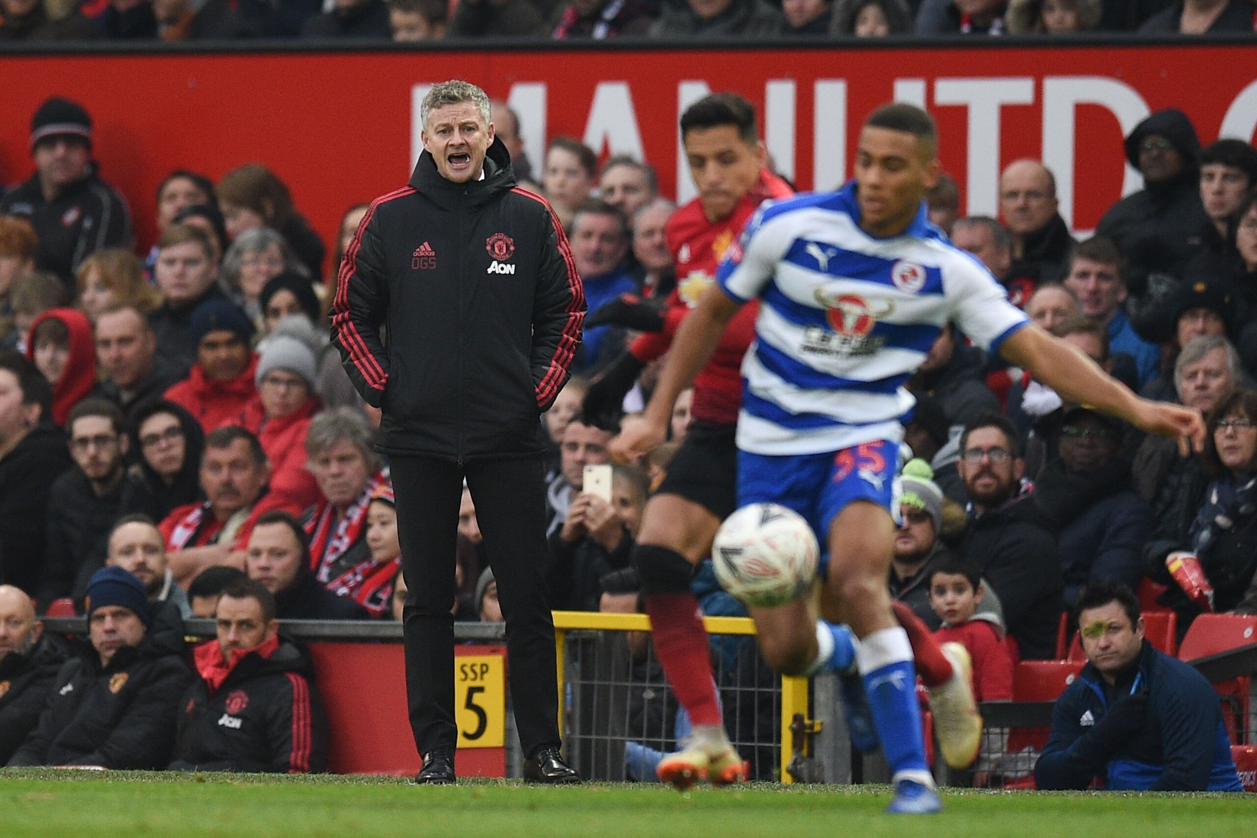 Manchester United's  Norwegian caretaker manager Ole Gunnar Solskjaer (L) shouts from the touchline during the English FA Cup third round football match between Manchester United and Reading at Old Trafford in Manchester, north west England, on January 5,