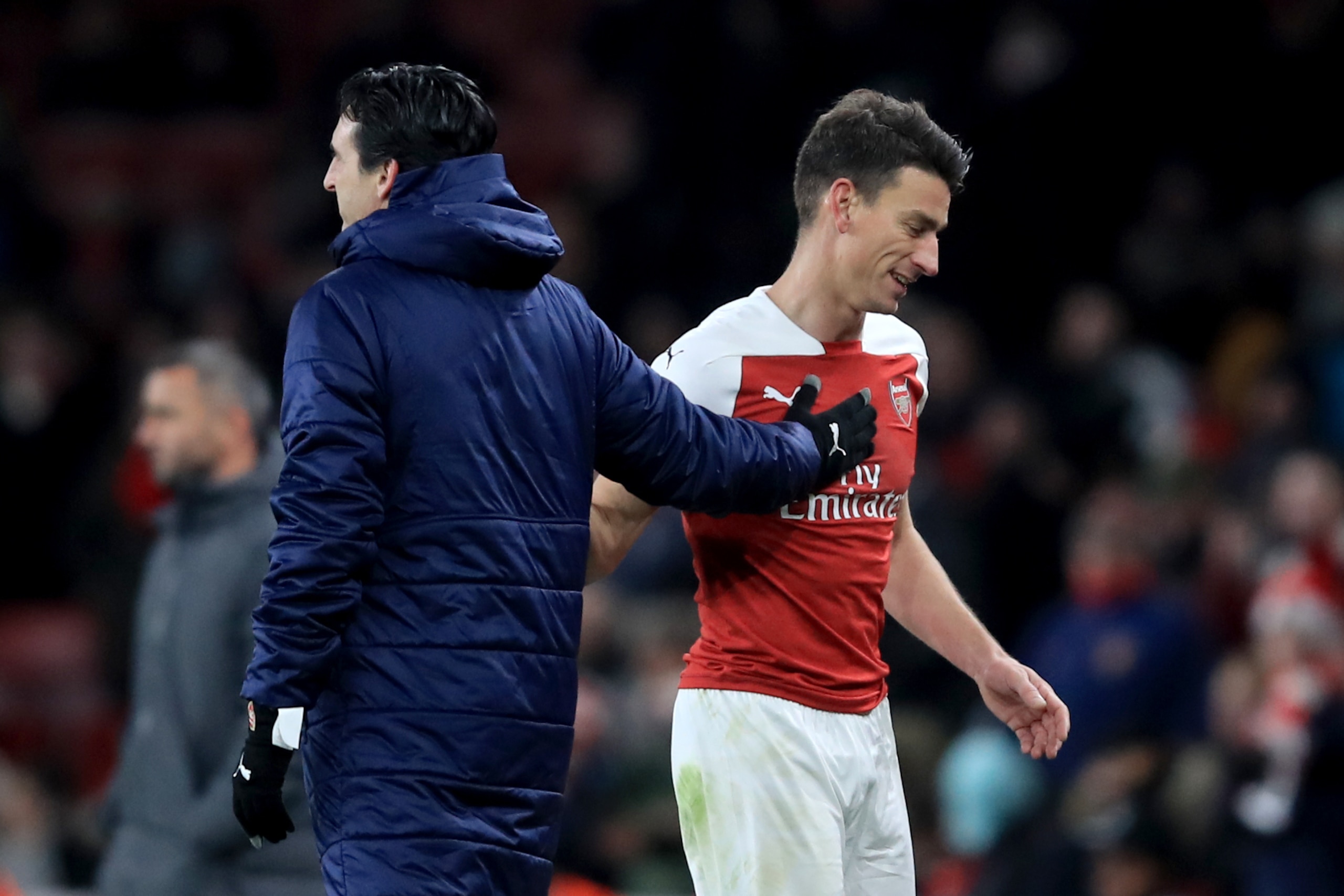 LONDON, ENGLAND - DECEMBER 13: Laurent Koscielny of Arsenal with Unai Emery manager of Arsenal during the UEFA Europa League Group E match between Arsenal and Qarabag FK at Emirates Stadium on December 13, 2018 in London, United Kingdom. (Photo by Marc At