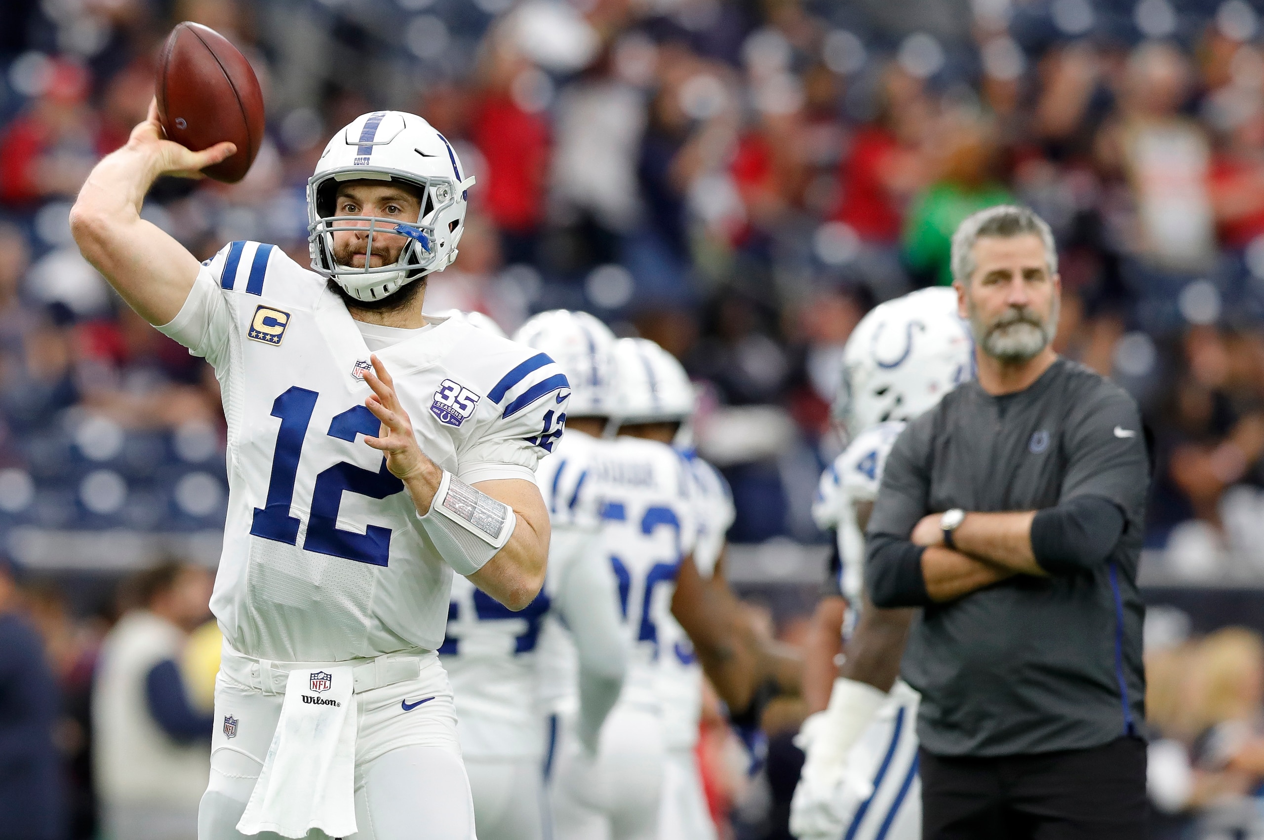 HOUSTON, TX - JANUARY 05: Andrew Luck #12 of the Indianapolis Colts throws a pass as head coach Frank Reich watches before the game against the Houston Texans during the Wild Card Round at NRG Stadium on January 5, 2019 in Houston, Texas. (Photo by Tim HOUSTON, TX - JANUARY 05: Andrew Luck #12 of the Indianapolis Colts throws a pass as head coach Frank Reich watches before the game against the Houston Texans during the Wild Card Round at NRG Stadium on January 5, 2019 in Houston, Texas. (Photo by Tim