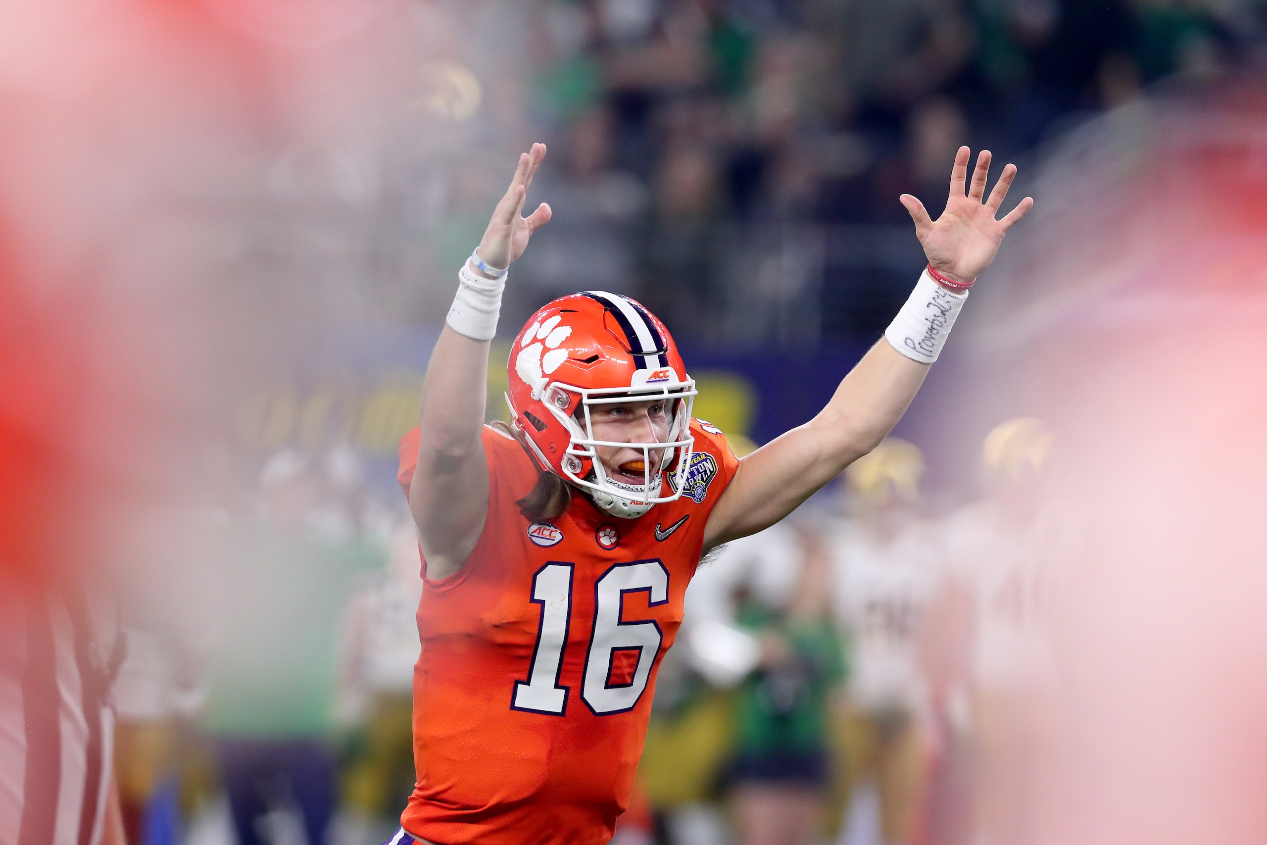 ARLINGTON, TEXAS - DECEMBER 29: Trevor Lawrence #16 of the Clemson Tigers reacts after throwing a 19 yard touchdown pass in the second quarter against the Notre Dame Fighting Irish during the College Football Playoff Semifinal Goodyear Cotton Bowl Classic