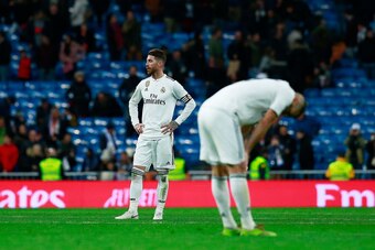 MADRID, SPAIN - JANUARY 06: Sergio Ramos (L) of Real Madrid CF and his teammate Karim Benzema (R) react as he leaves the pitch after loosing the La Liga match between Real Madrid CF and Real Sociedad de Futbol at Estadio Santiago Bernabeu on January 06, 2