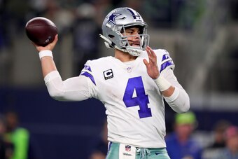 ARLINGTON, TEXAS - JANUARY 05:  Dak Prescott #4 of the Dallas Cowboys looks for an open receiver against the Seattle Seahawks in the fourth quarter during the Wild Card Round at AT&T Stadium on January 05, 2019 in Arlington, Texas. (Photo by Tom Penningto