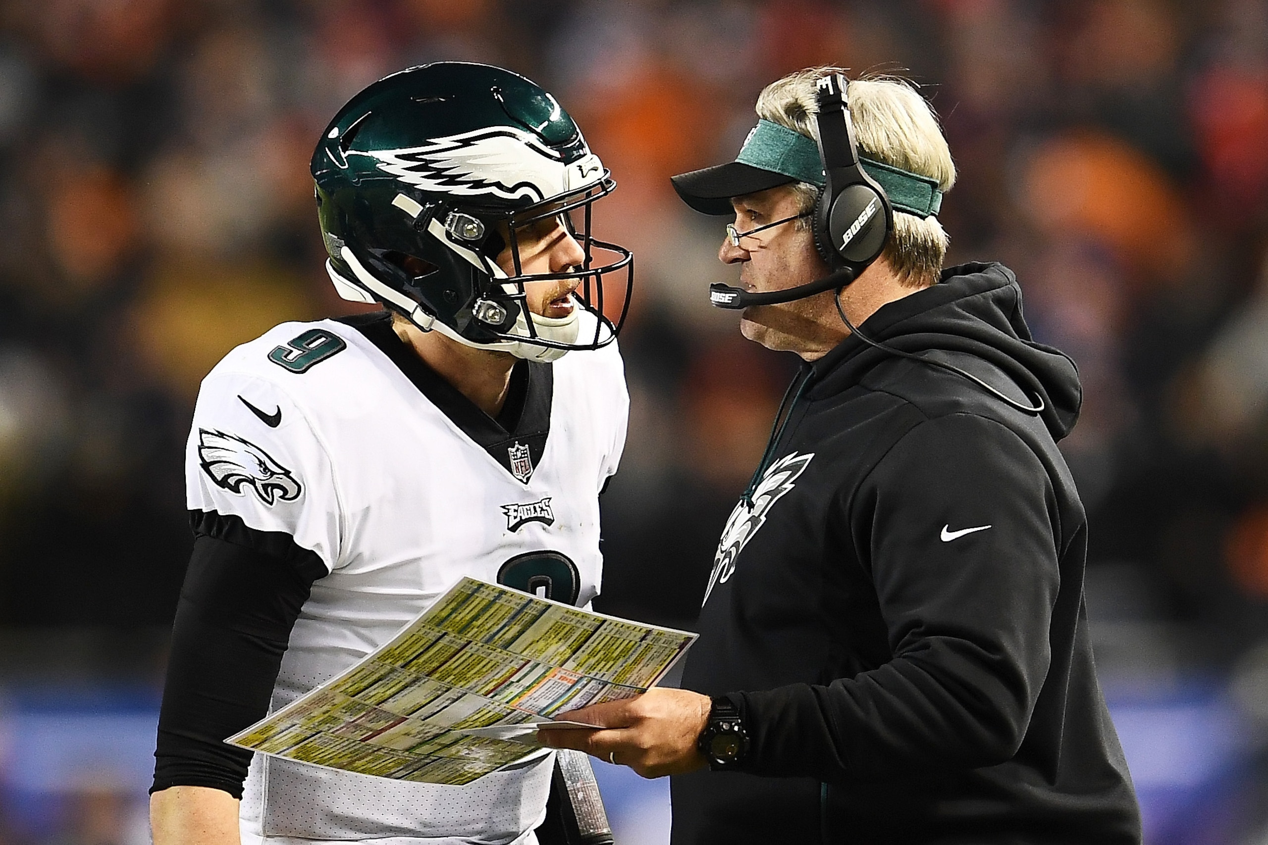 CHICAGO, ILLINOIS - JANUARY 06:  Head coach Doug Pederson talks to Nick Foles #9 of the Philadelphia Eagles against the Chicago Bears in the fourth quarter of the NFC Wild Card Playoff game at Soldier Field on January 06, 2019 in Chicago, Illinois. (Photo