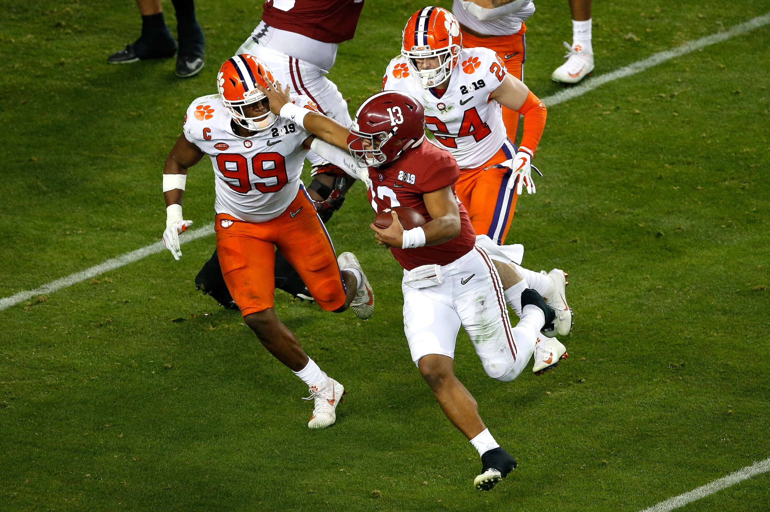 SANTA CLARA, CALIFORNIA - JANUARY 07: Clelin Ferrell #99 of the Clemson Tigers tackles Tua Tagovailoa #13 of the Alabama Crimson Tide on fourth down during the fourth quarter in the College Football Playoff National Championship at Levi's Stadium on Janua