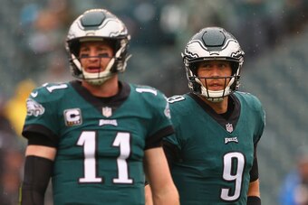 PHILADELPHIA, PA - SEPTEMBER 23:  (L-R) Quarterback Carson Wentz #11 of the Philadelphia Eagles and teammate quarterback Nick Foles #9 look on during warm ups before taking on the Indianapolis Colts at Lincoln Financial Field on September 23, 2018 in Phil
