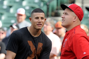 BALTIMORE, MD - MAY 15:  Manny Machado #13 of the Baltimore Orioles talks with Mike Trout #27 of the Los Angeles Angels during batting practice before the game at Oriole Park at Camden Yards on May 15, 2015 in Baltimore, Maryland.  (Photo by G Fiume/Getty