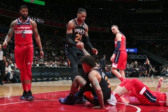WASHINGTON, DC - DECEMBER 22: Richaun Holmes #21 helps up Kelly Oubre Jr. #3 of the Phoenix Suns during the game against the Washington Wizards on December 22, 2018 at Capital One Arena in Washington, DC. NOTE TO USER: User expressly acknowledges and agre